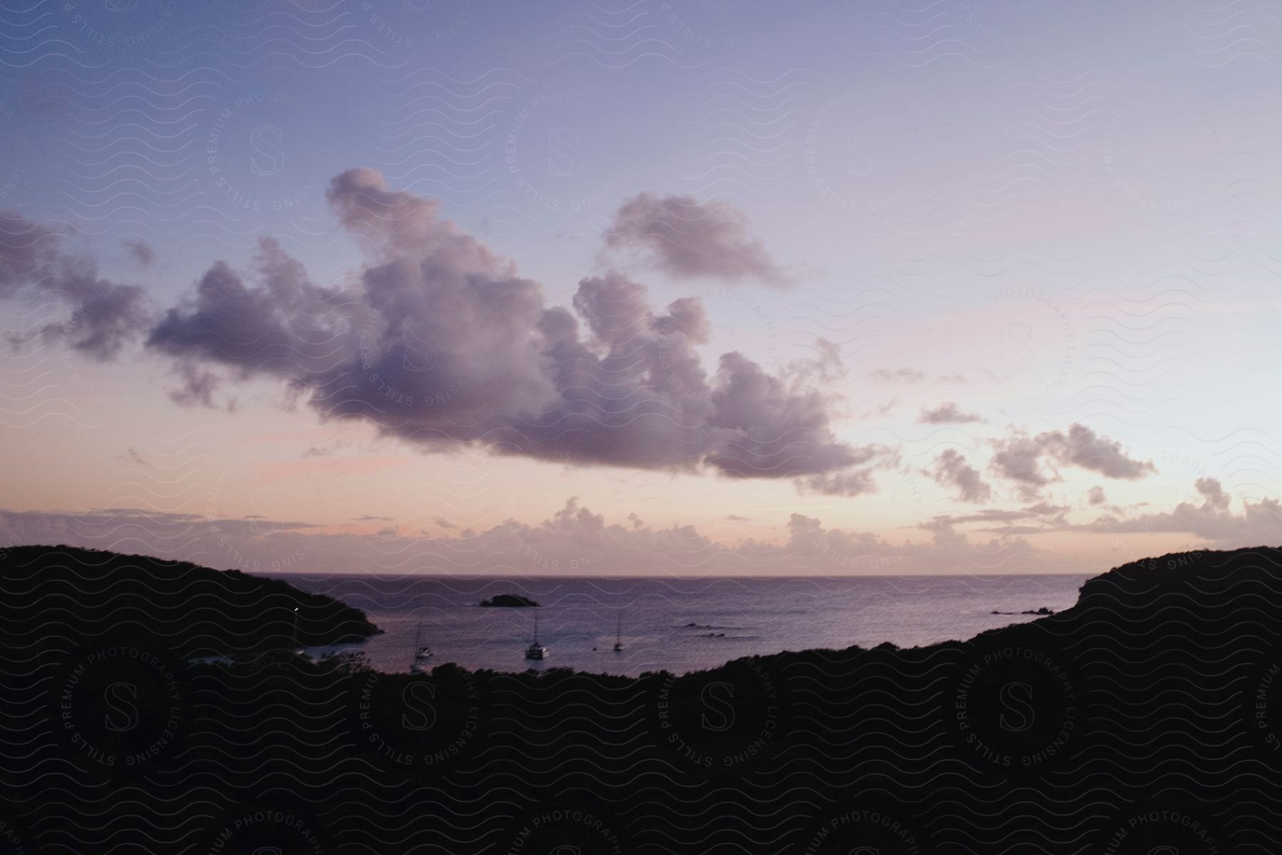 Silhouette landscape of the coast by the sea in a morning with a purple sky