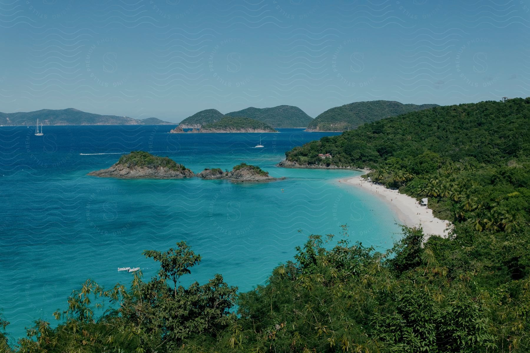 Azure water on a tropical coast scattered with boats.