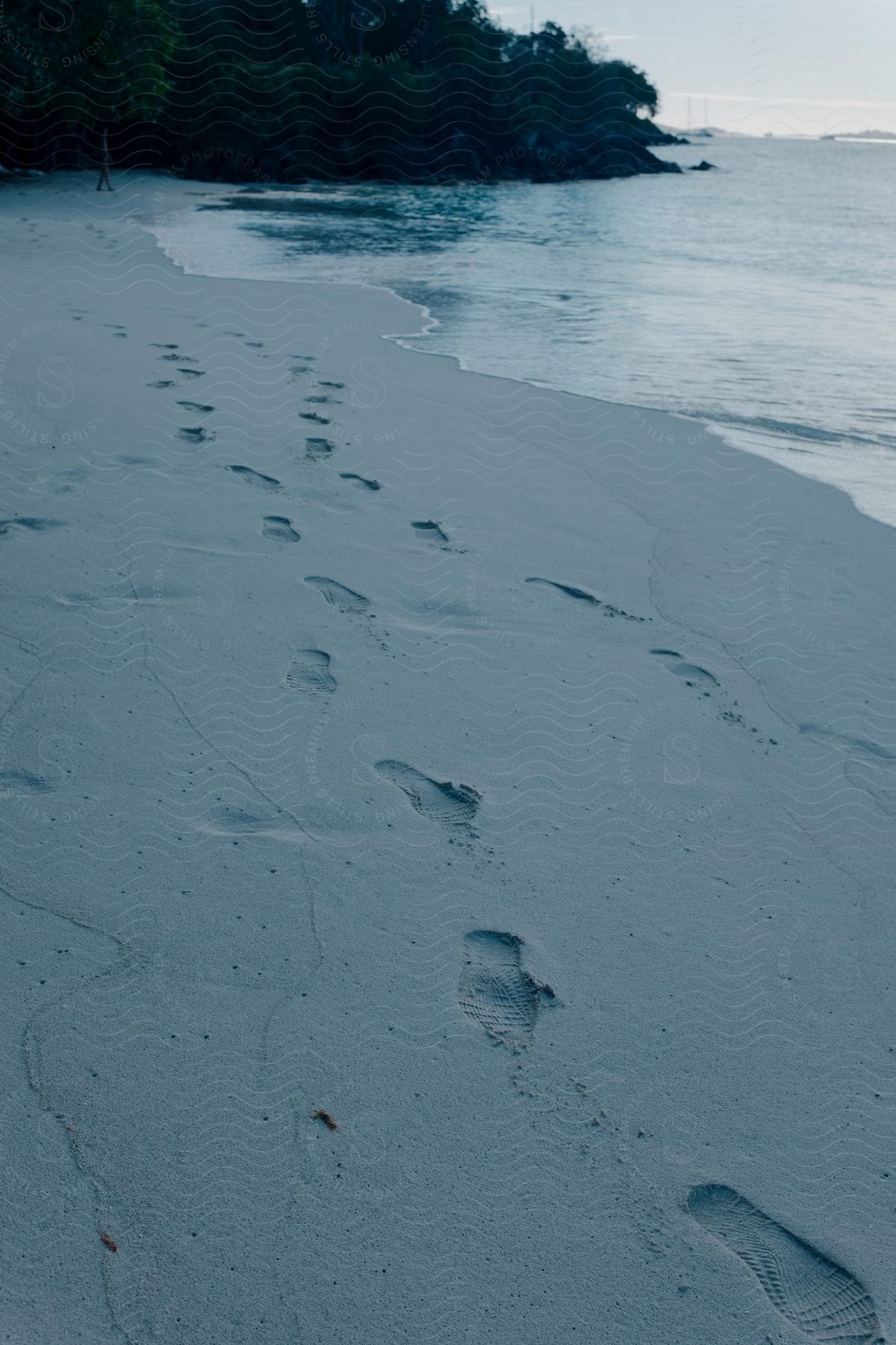 Beach landscape with footprints of a person's feet on the sand