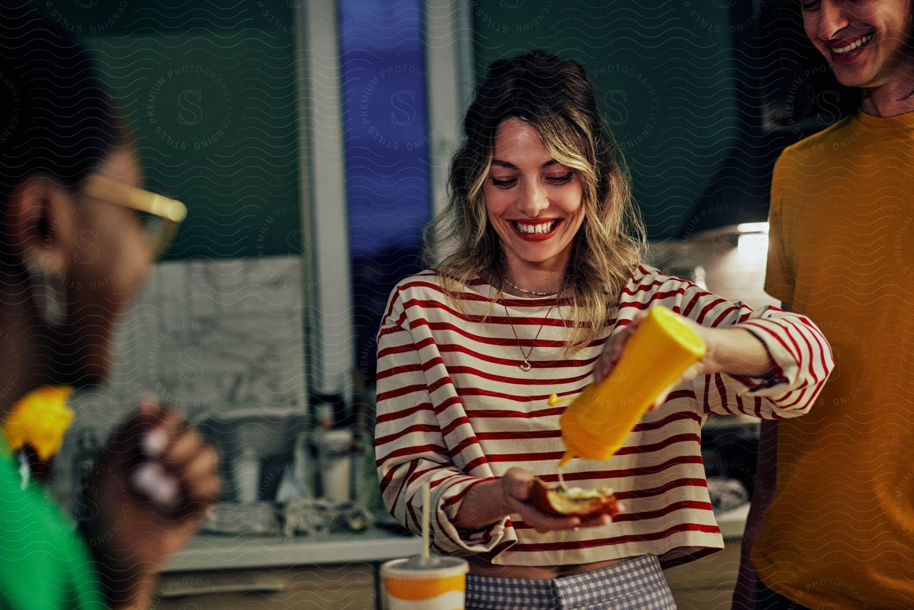 Friends having fun while preparing hot dogs together.