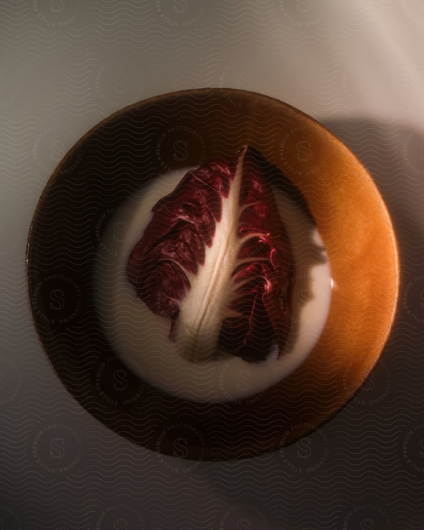 A porcelain bowl with vegetable soup.