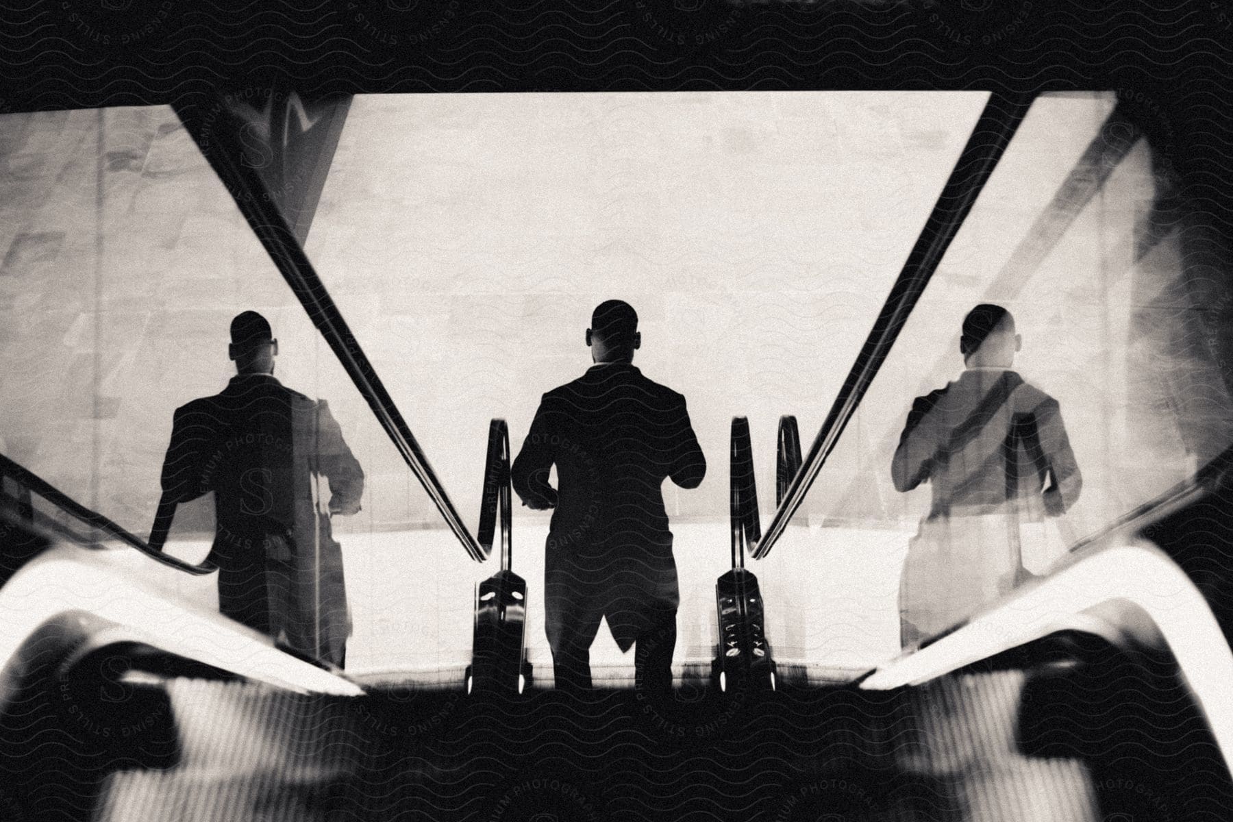 Stock photo of a man riding down an escalator