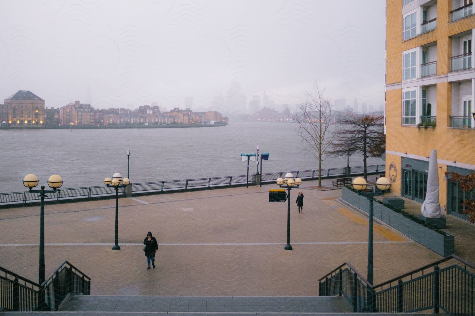 View of a lake on a cloudy day in the middle of a metropolitan city