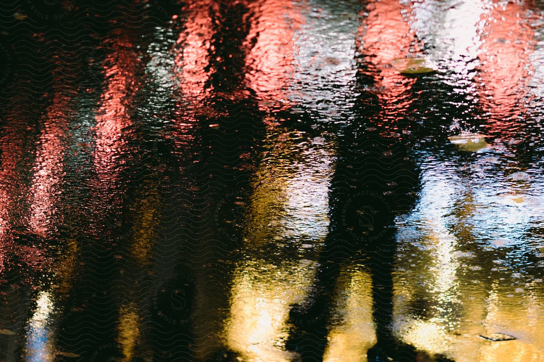 A Group Of People On A Blurry Street At Night