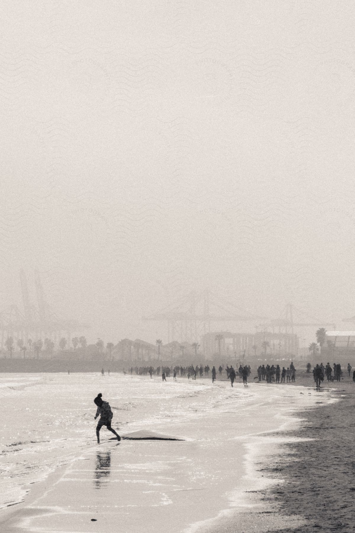 Stock photo of an old photo of a lot of people at the beach.