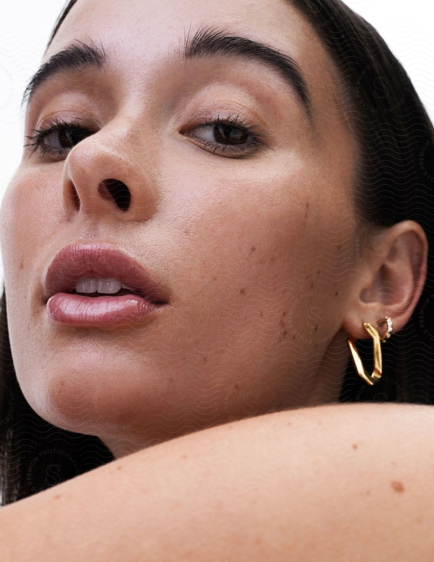 Portrait of a model wearing painted earrings