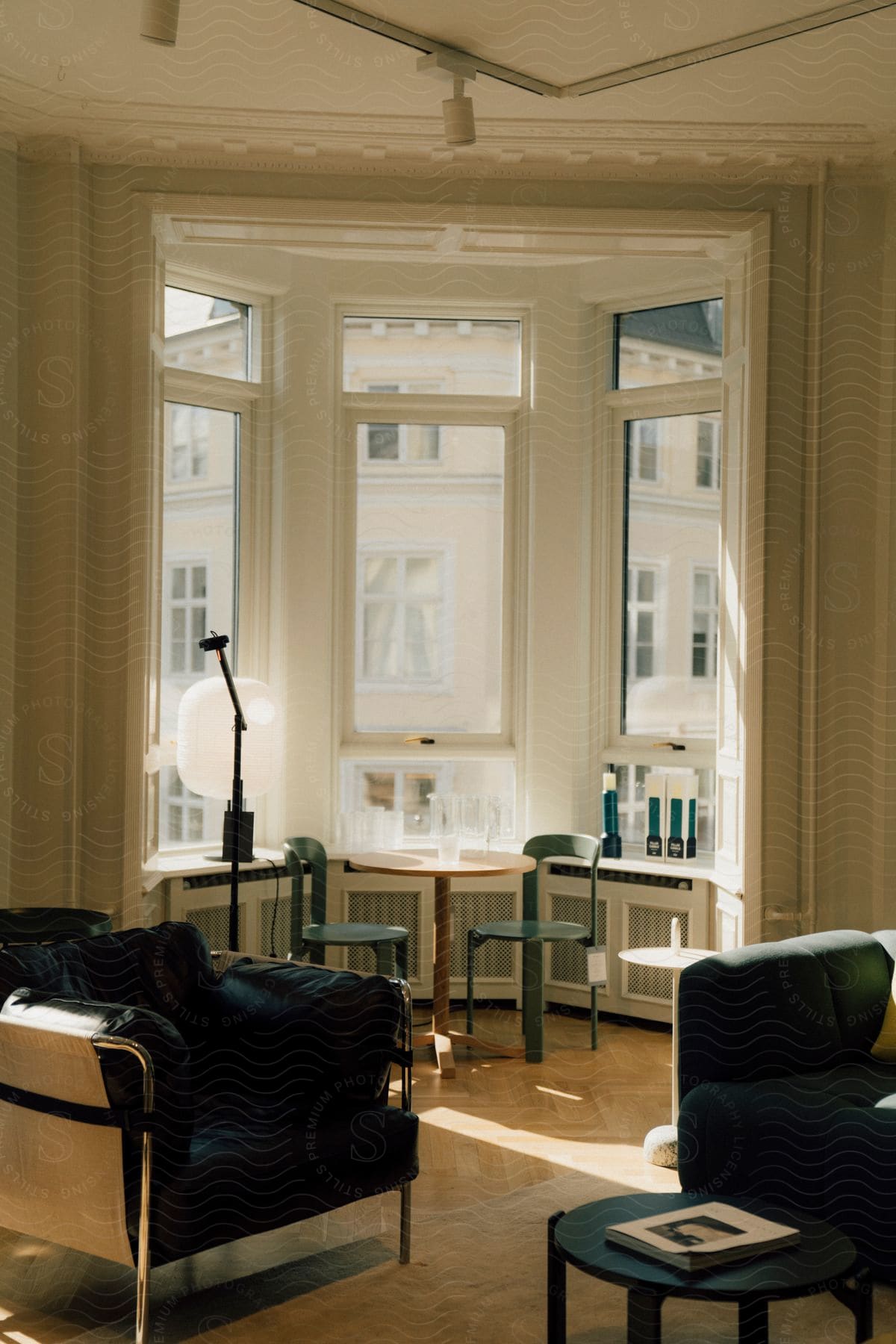 Interior design of armchairs at a small table next to the window of a building