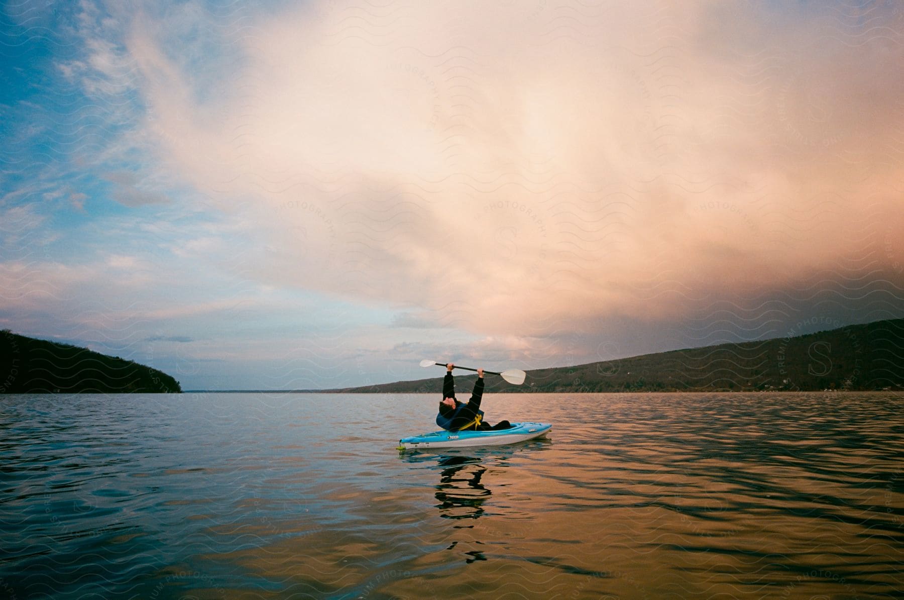 A hot of a person in a canoe both in the river