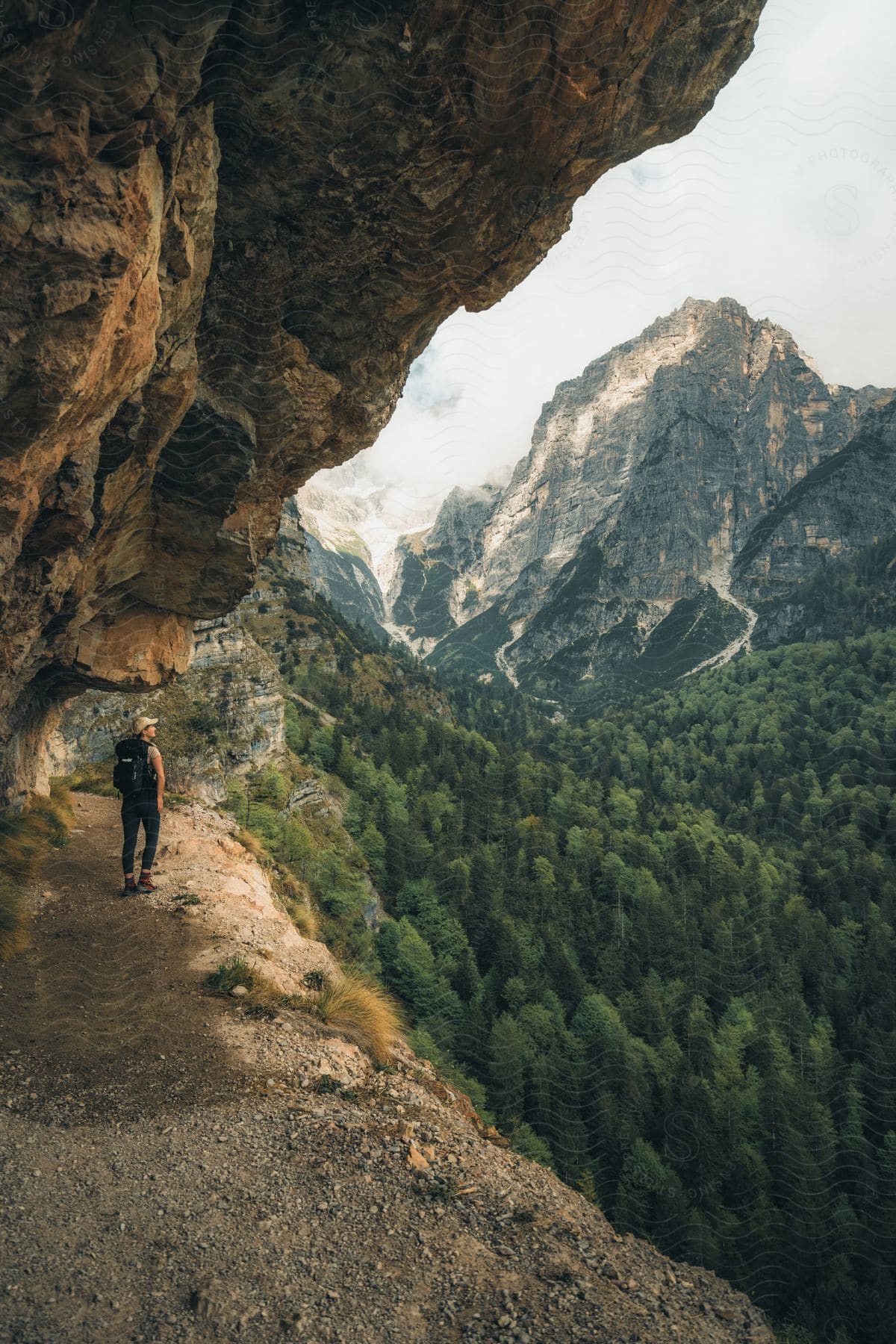 A woman hiking outdoors on a sunny day.