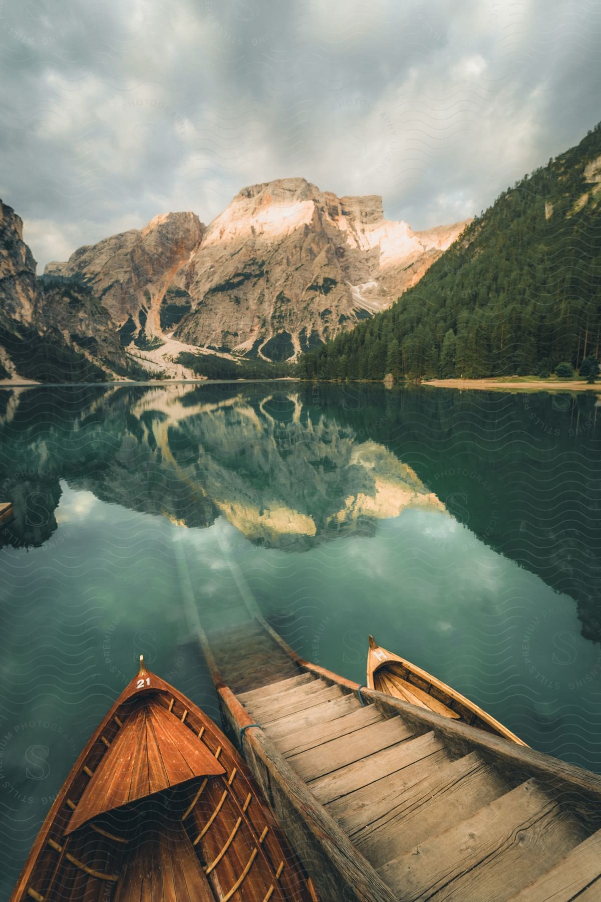 Natural landscape of the Pragser Wildsee with an access bridge and surrounding mountains