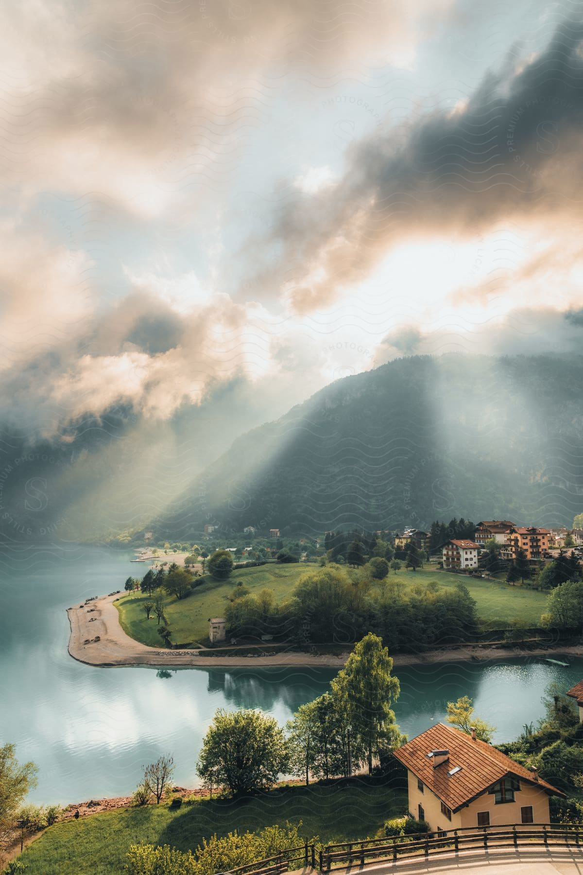 A view of some houses in a rural area along some water.