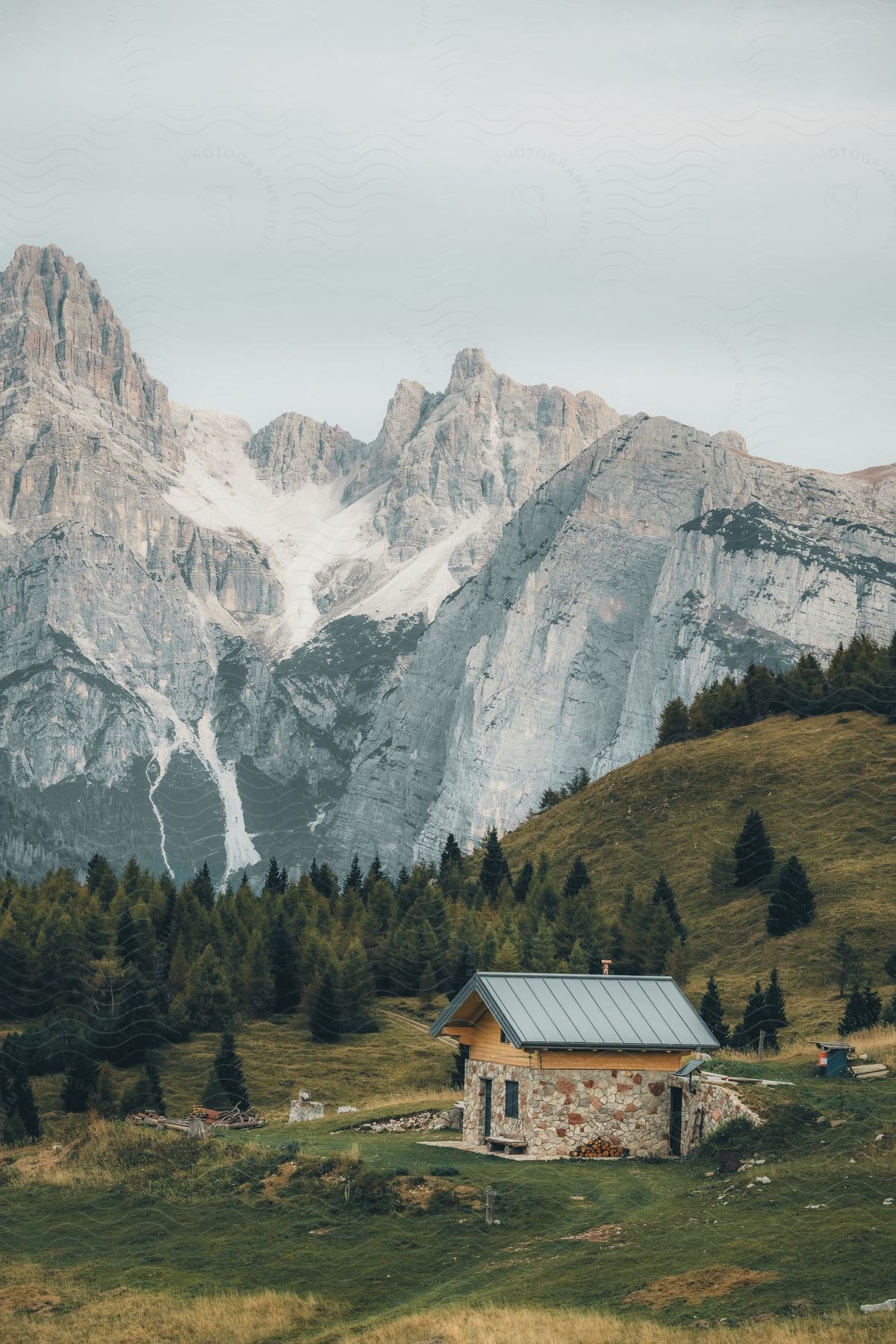 A view of a rural house in a mountain range.