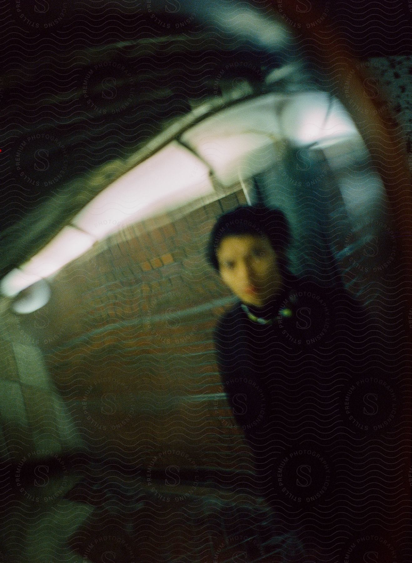 A blurry image of a man standing in a subway station