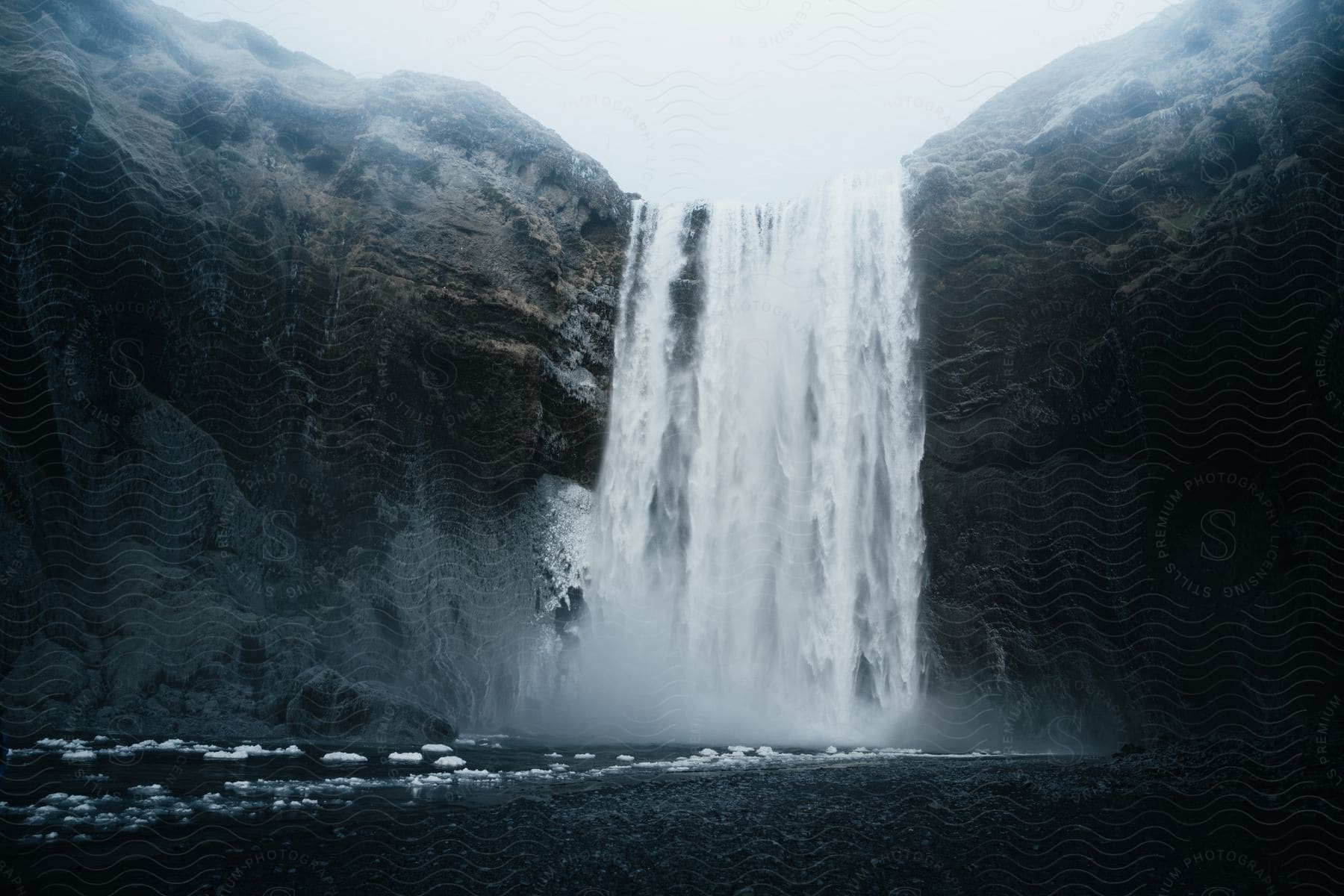 powerful waterfall cascades over a rugged cliff face