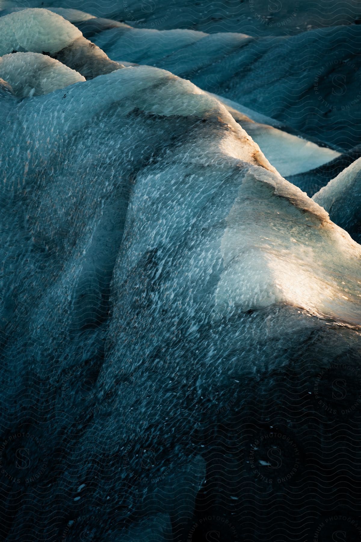 An ice cap on the edge of a beach at sunset.