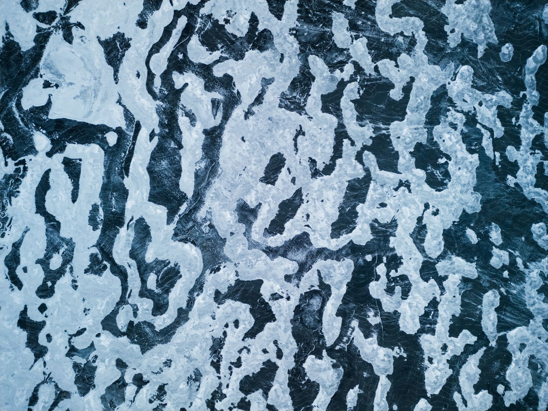 Top-down aerial view of the arctic ice cap melting