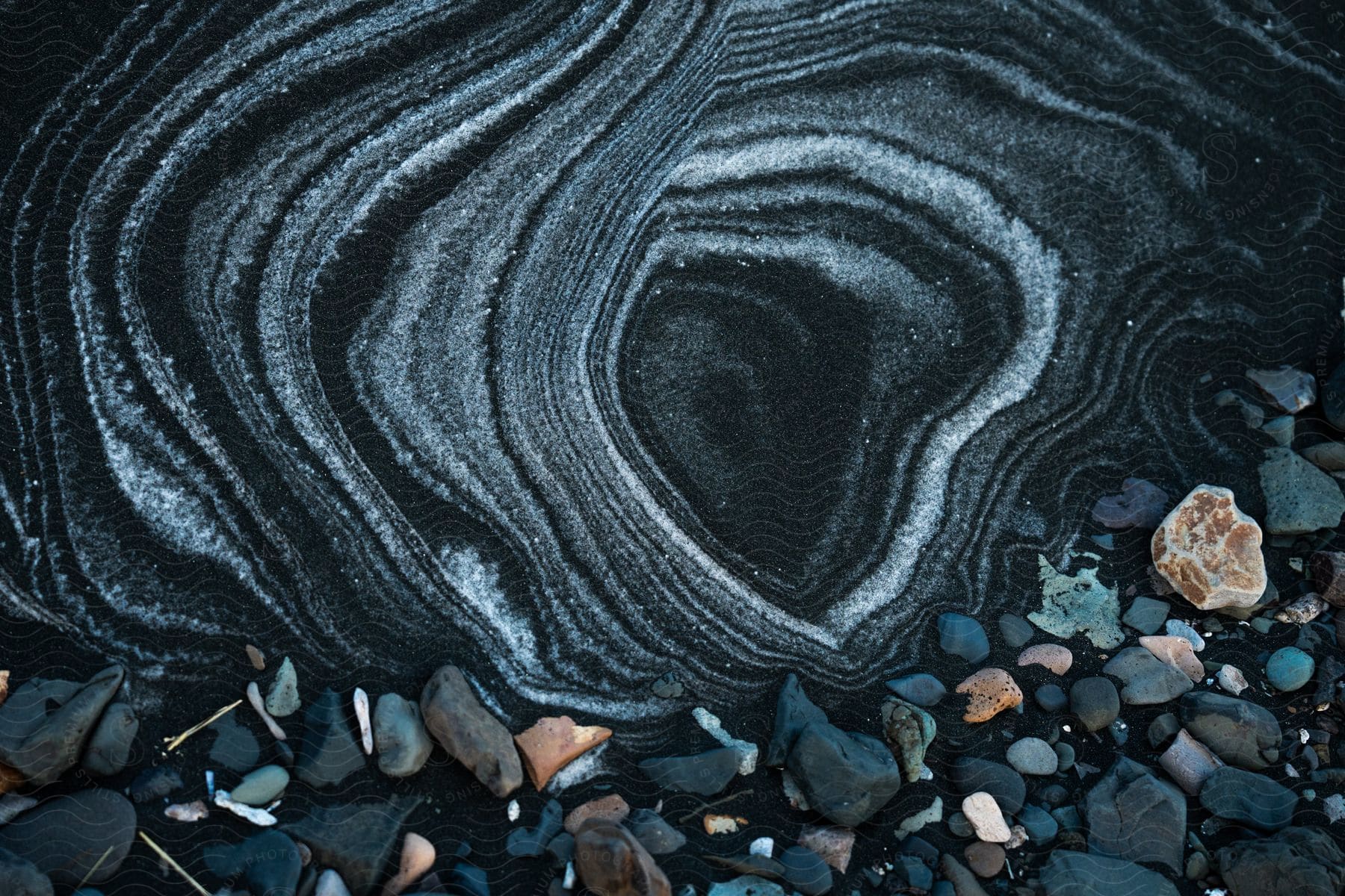 Sandy soil with dark sand with stones.