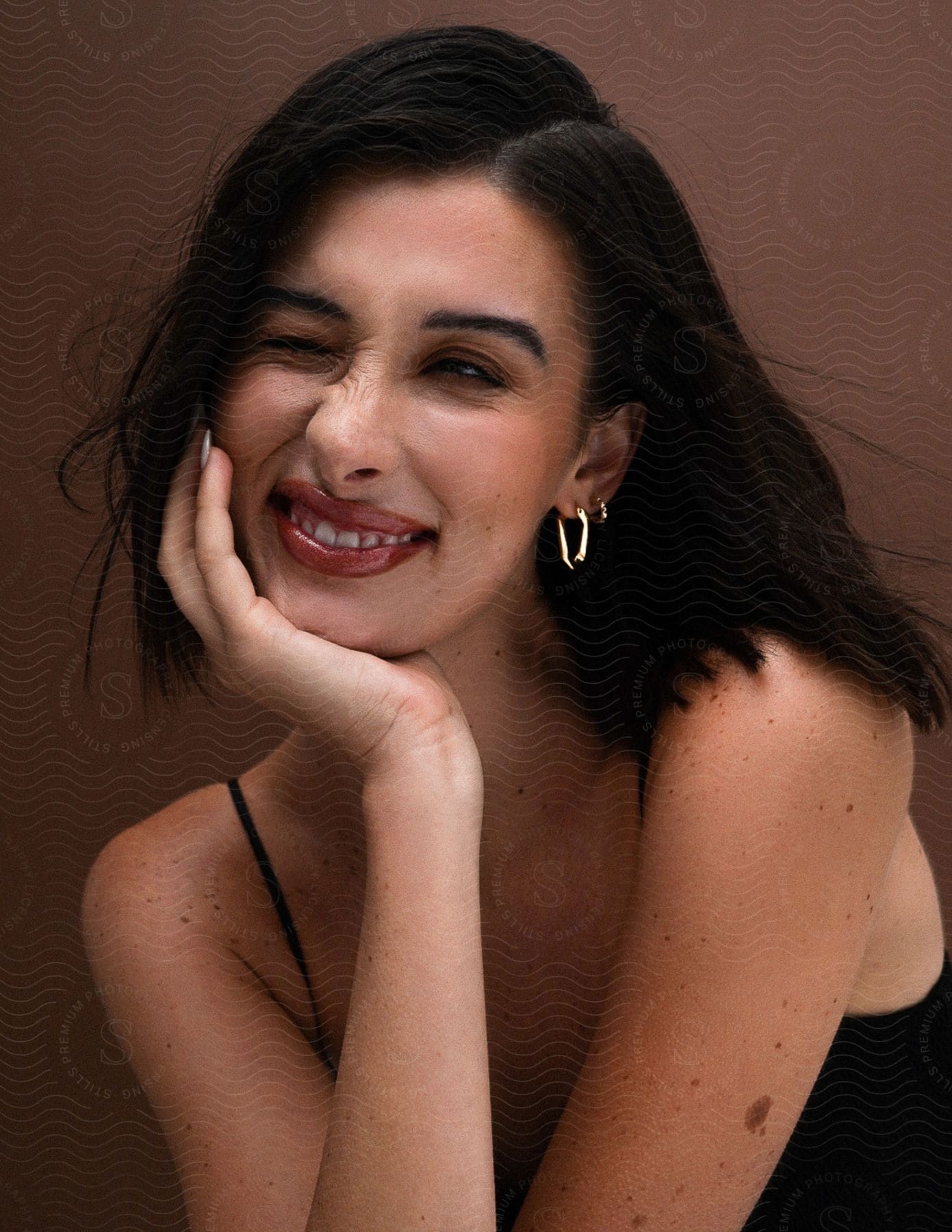 Portrait of a young woman winking and smiling.