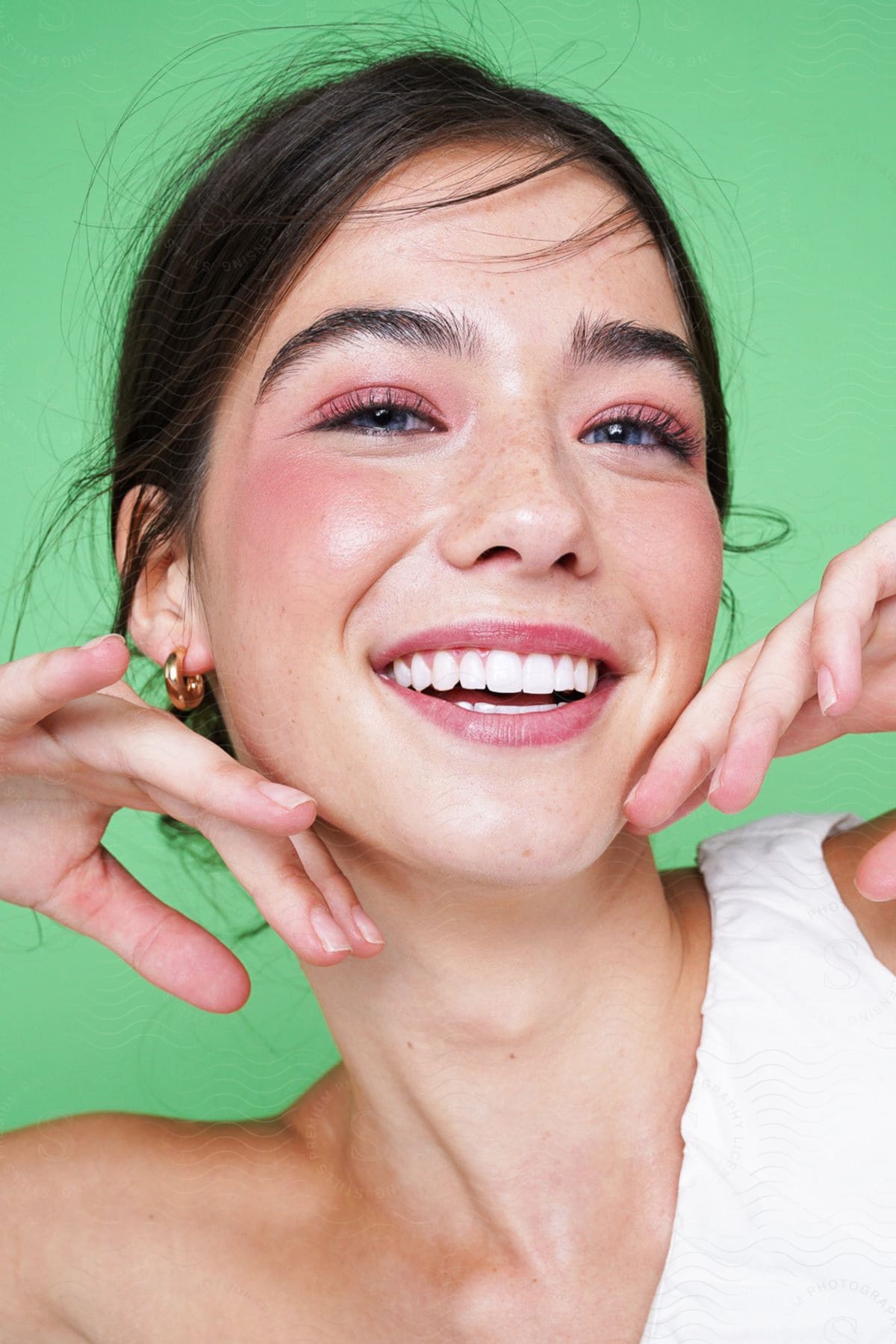 A Teenage Girl With A Big Smile On Her Face And Her Hands Touching Her Jaw