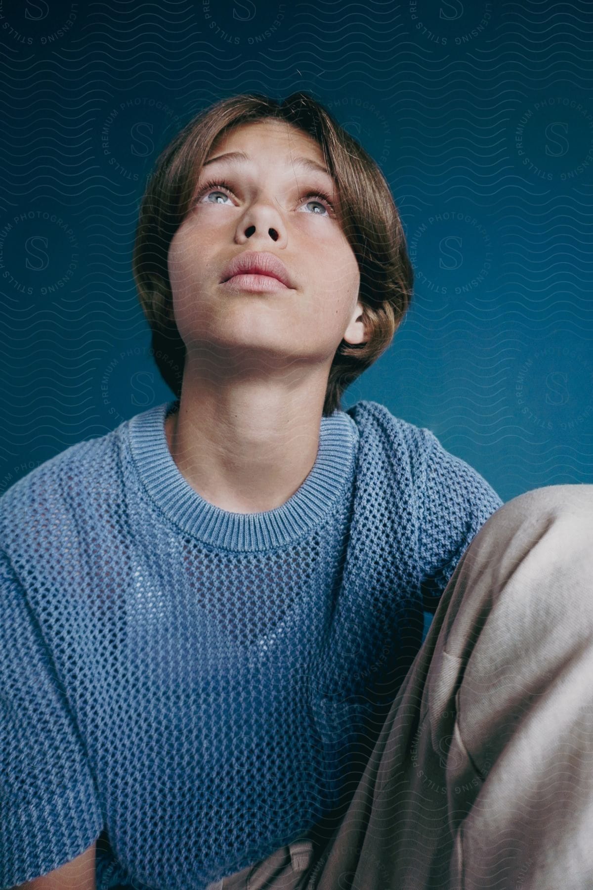 A portrait of a person sitting around in a studio