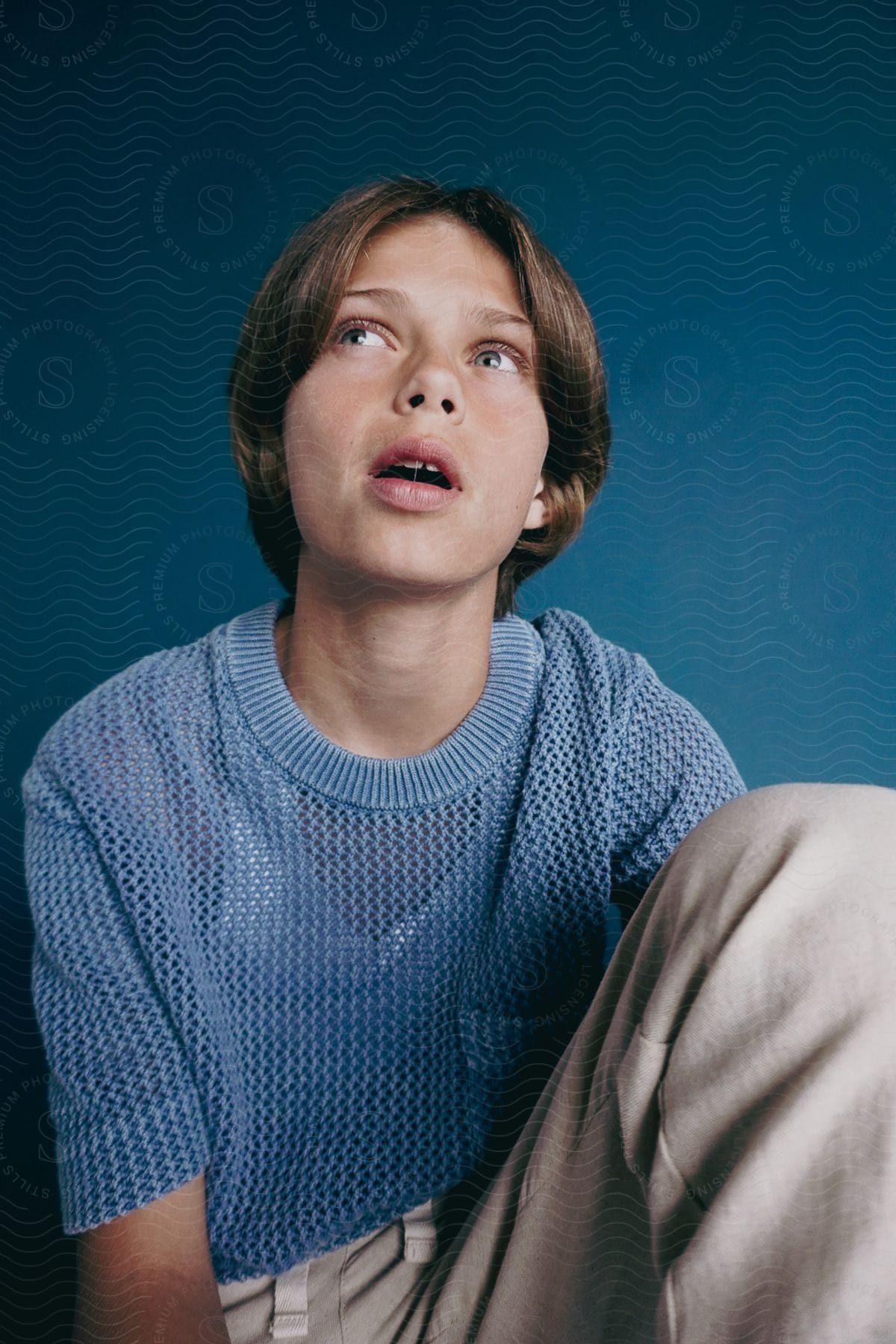 A portrait of a person sitting in a studio