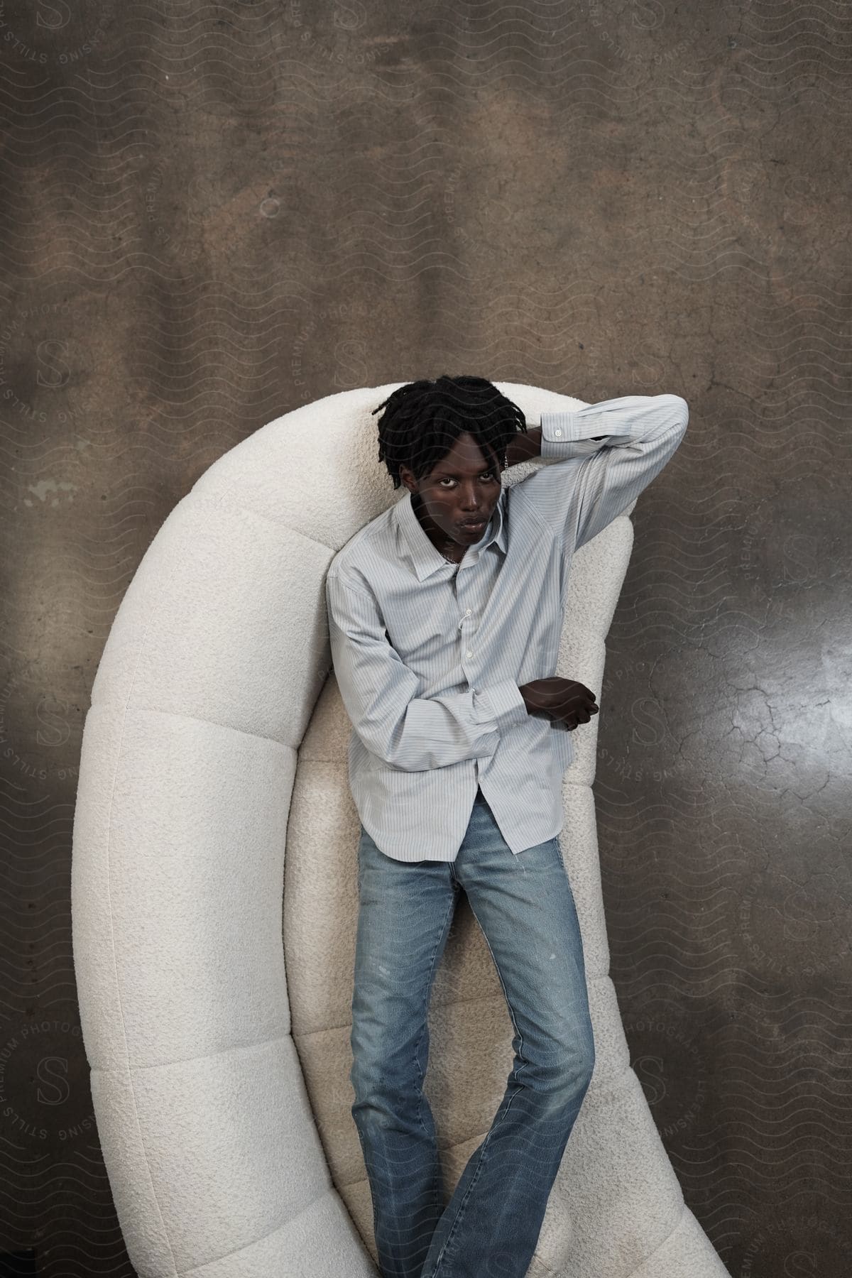 View from above as a man lies on a couch looking up