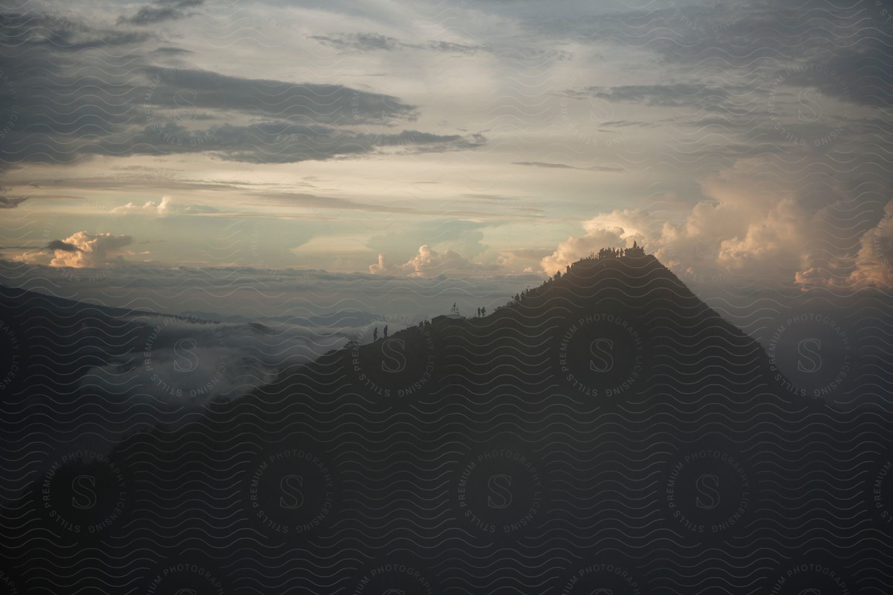 Mystical dawn over a cloud-enshrouded mountain peak.