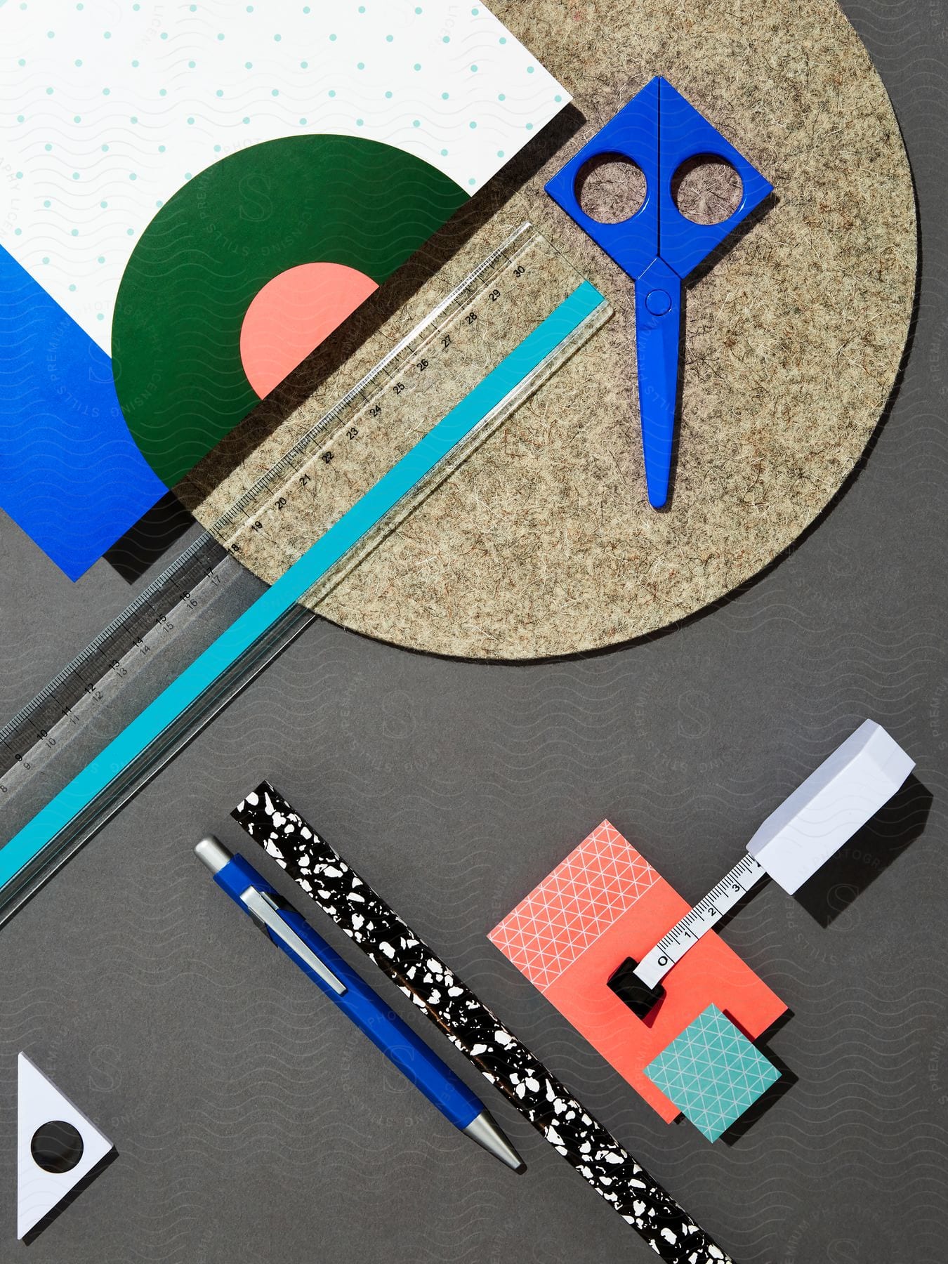 An artistic and colorful still life of rulers scissors and drafting tools