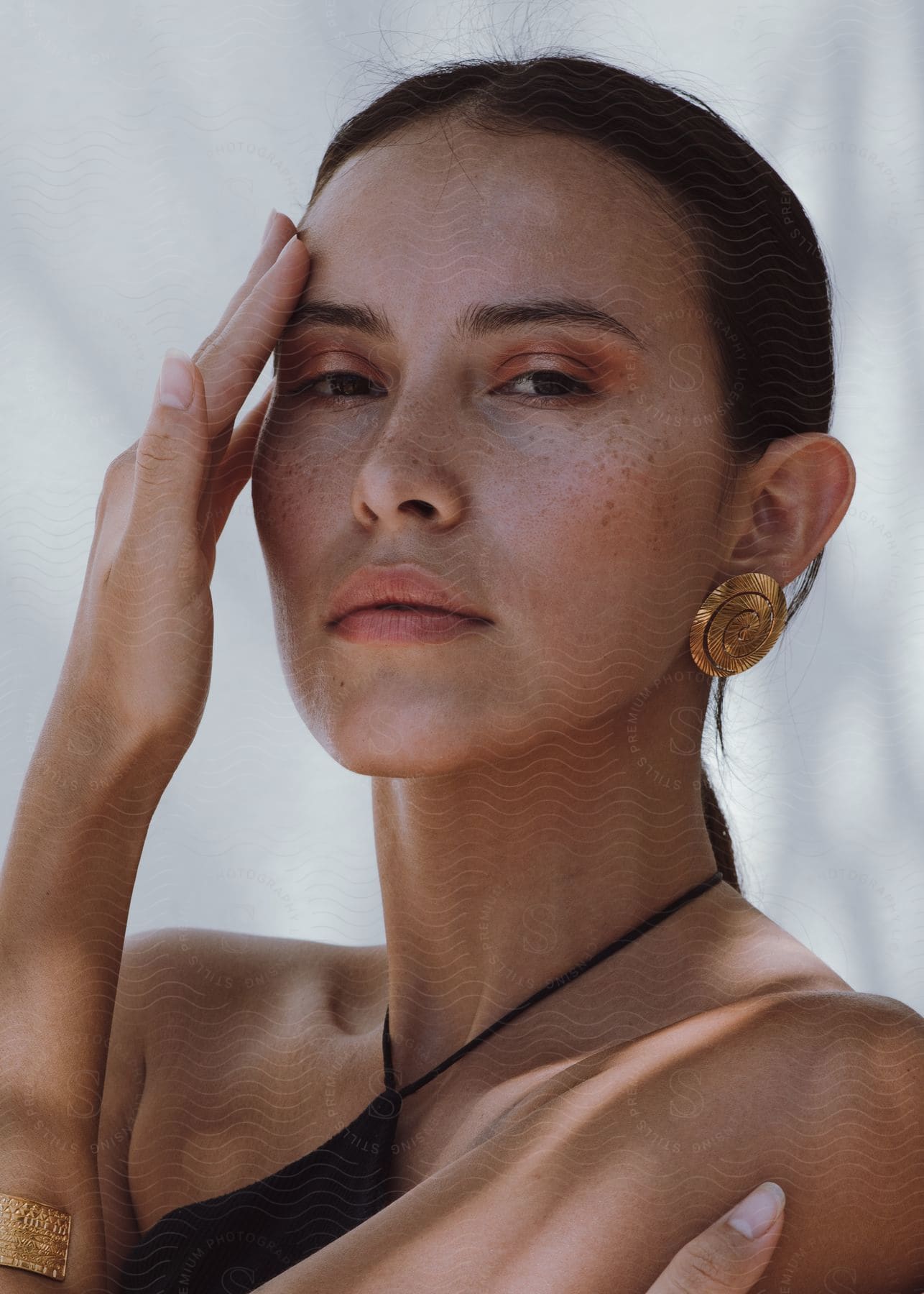 Close-up of a woman's face with freckles on her nose.