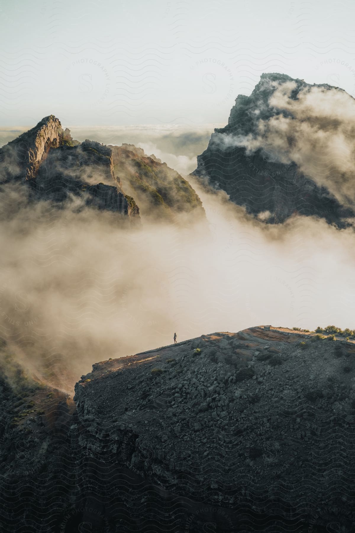 A view of a mountain range outdoors with some clouds.