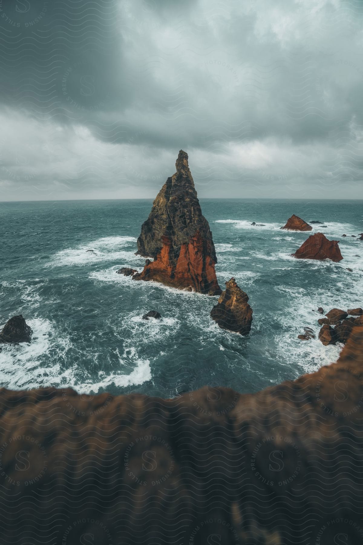 A view of some rocks pointing out of the ocean.