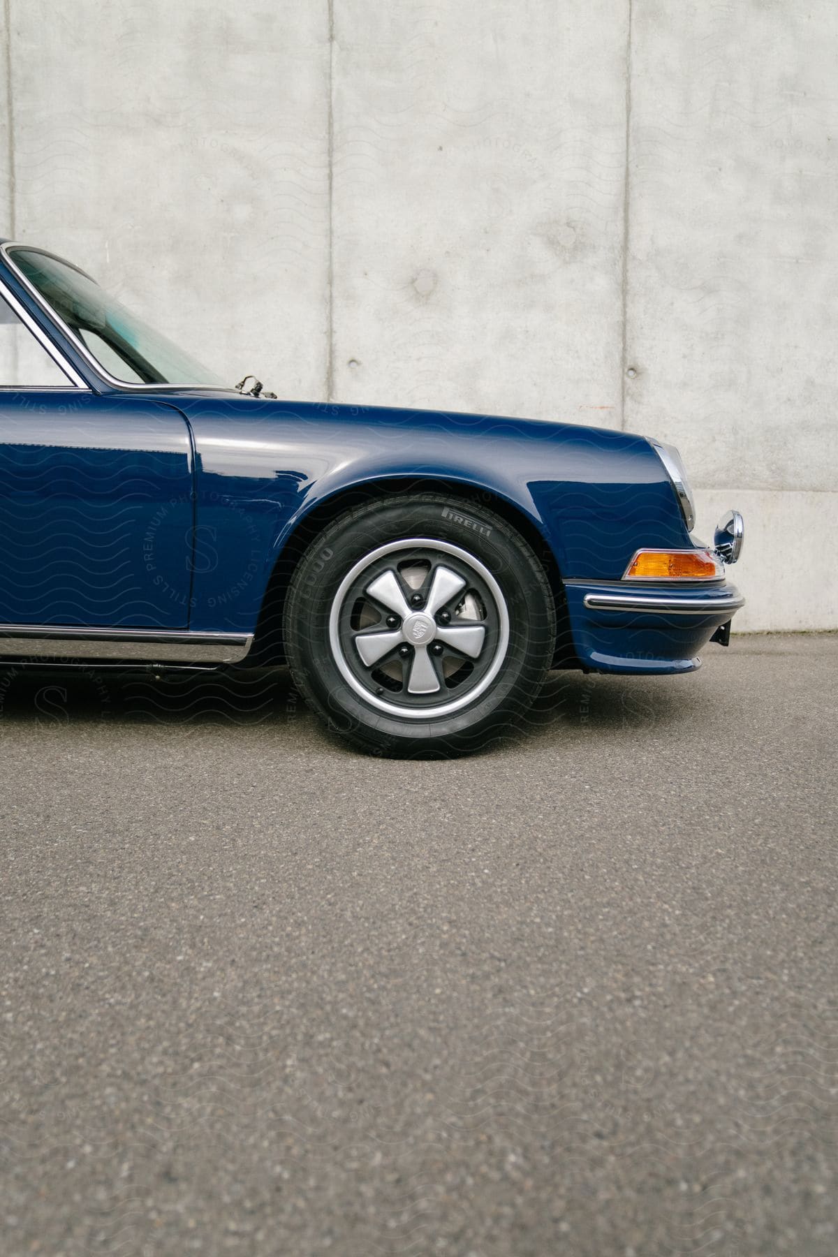 The front half side view of a blue vintage porsche