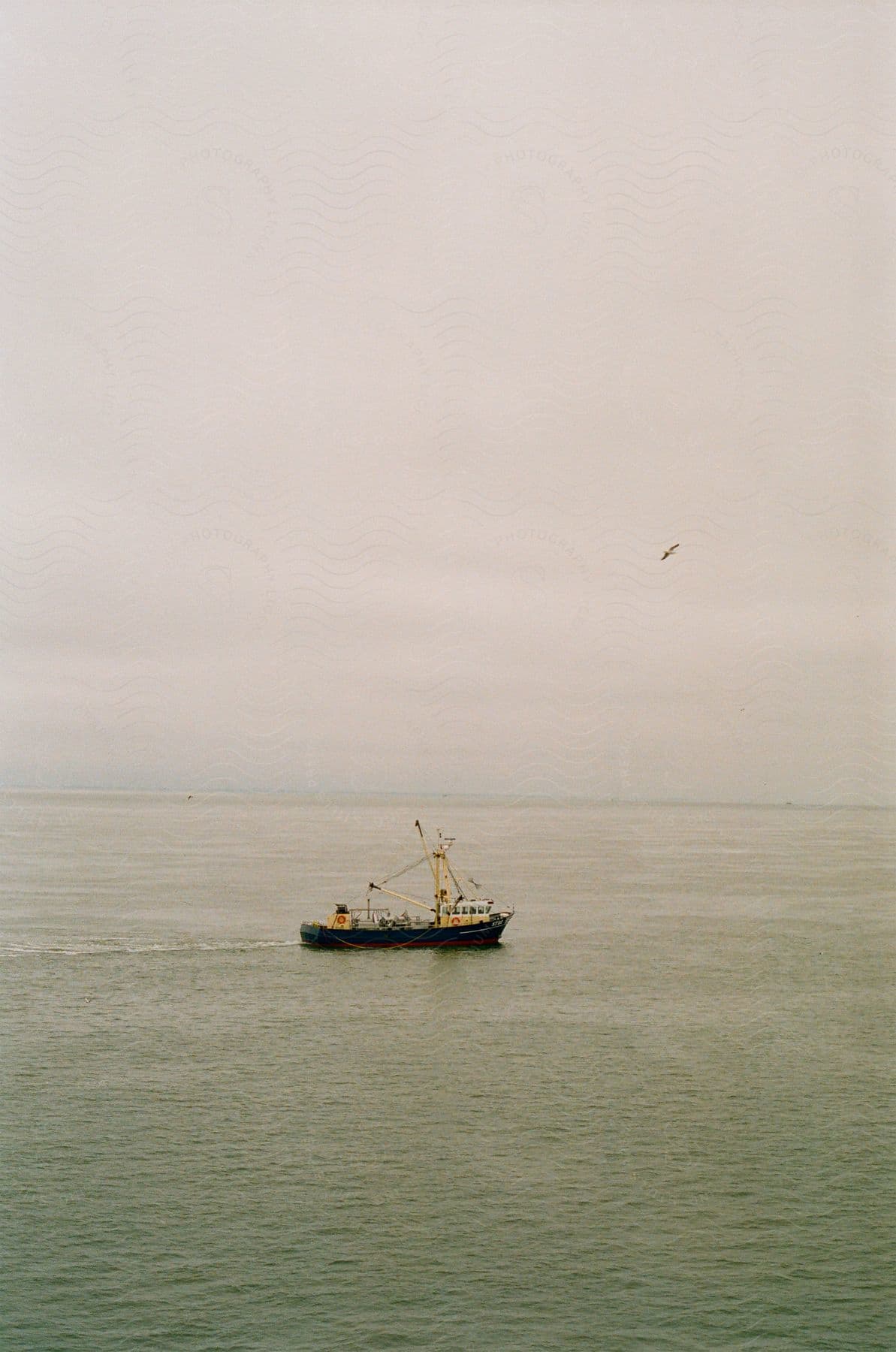 a small cargo ship on the sea at daytime