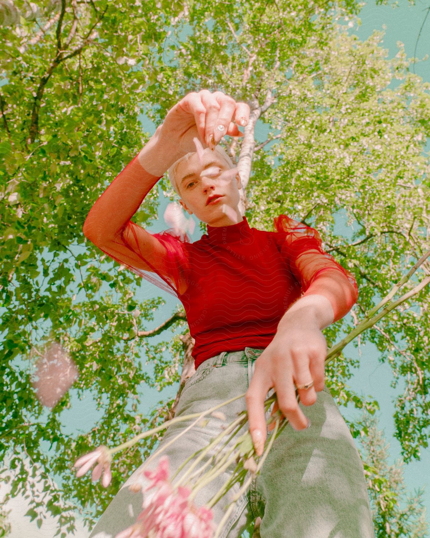 Woman dropping petals on to the camera