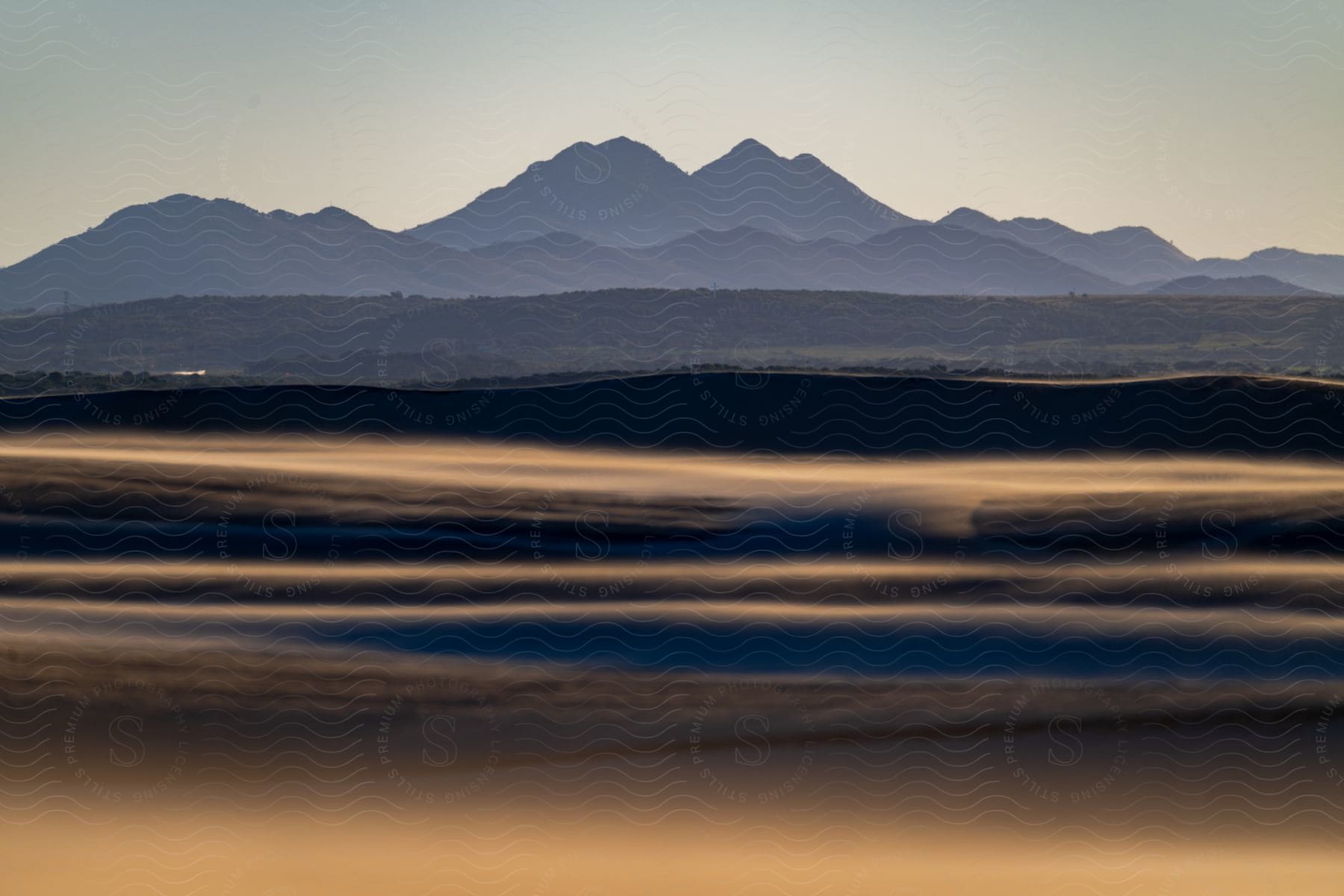 Sand dunes with mountains in the distance