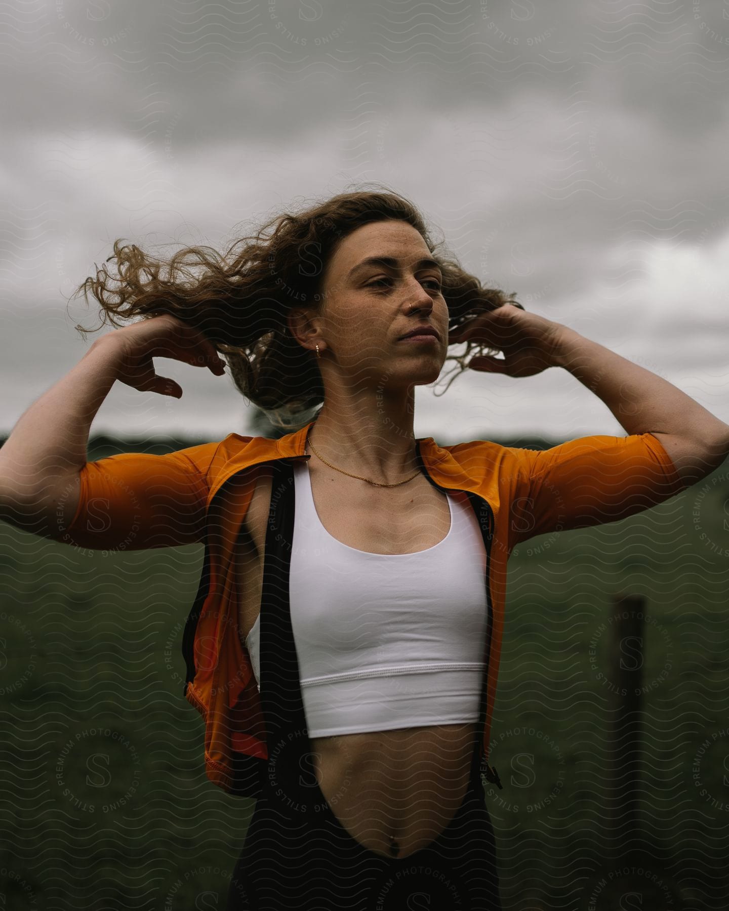 A portrait of a woman modeling clothes outdoors