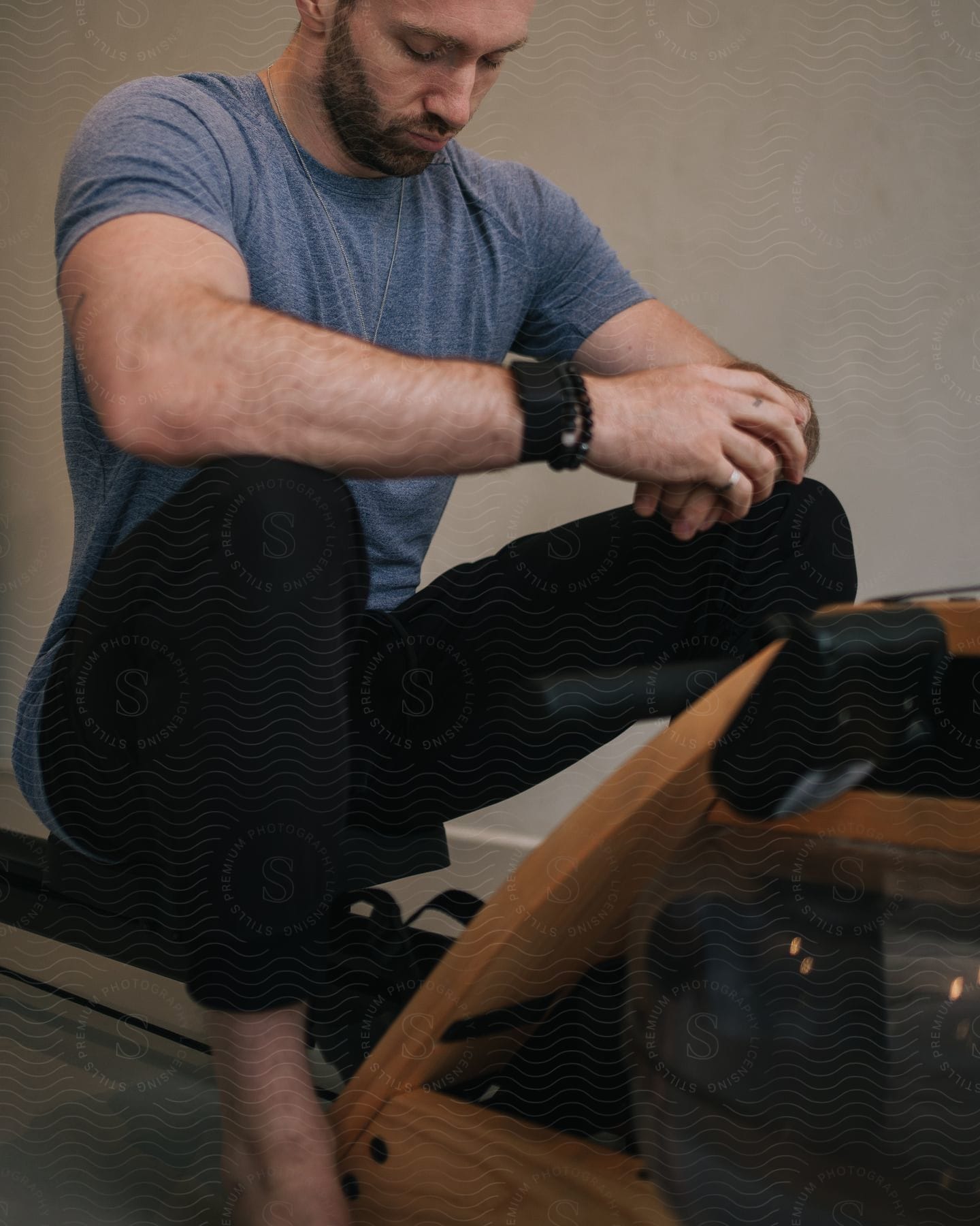 A man sitting at a rowing machine in a gym