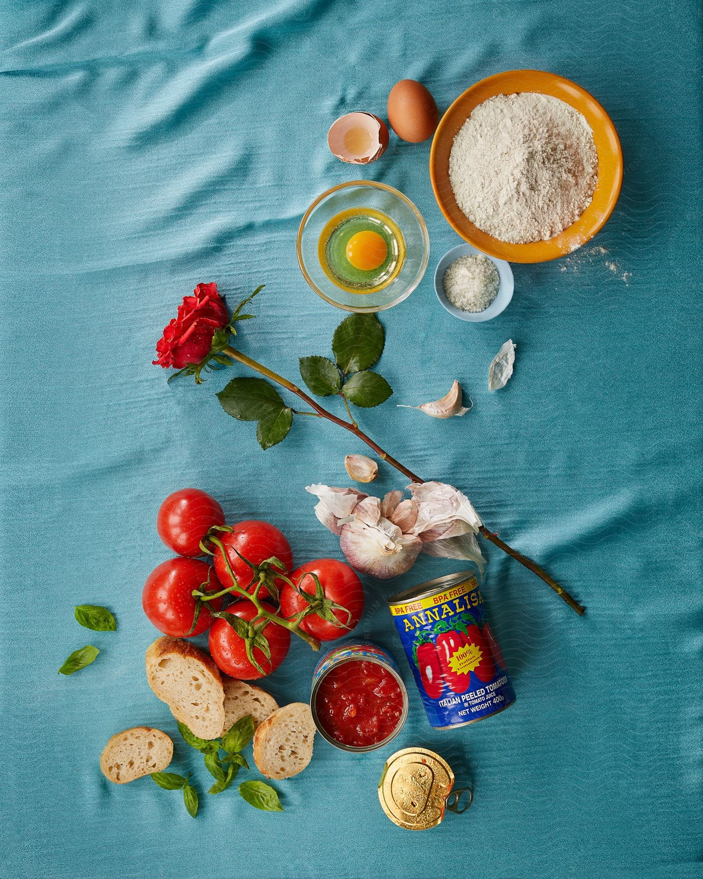 food reparation with fresh tomatoes, tomato paste, bread crumbs , eggs and a flower