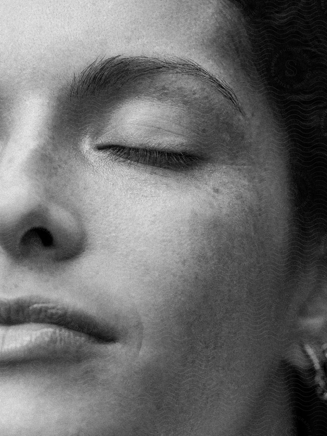 Close up of half of a woman's face with her eyes closed