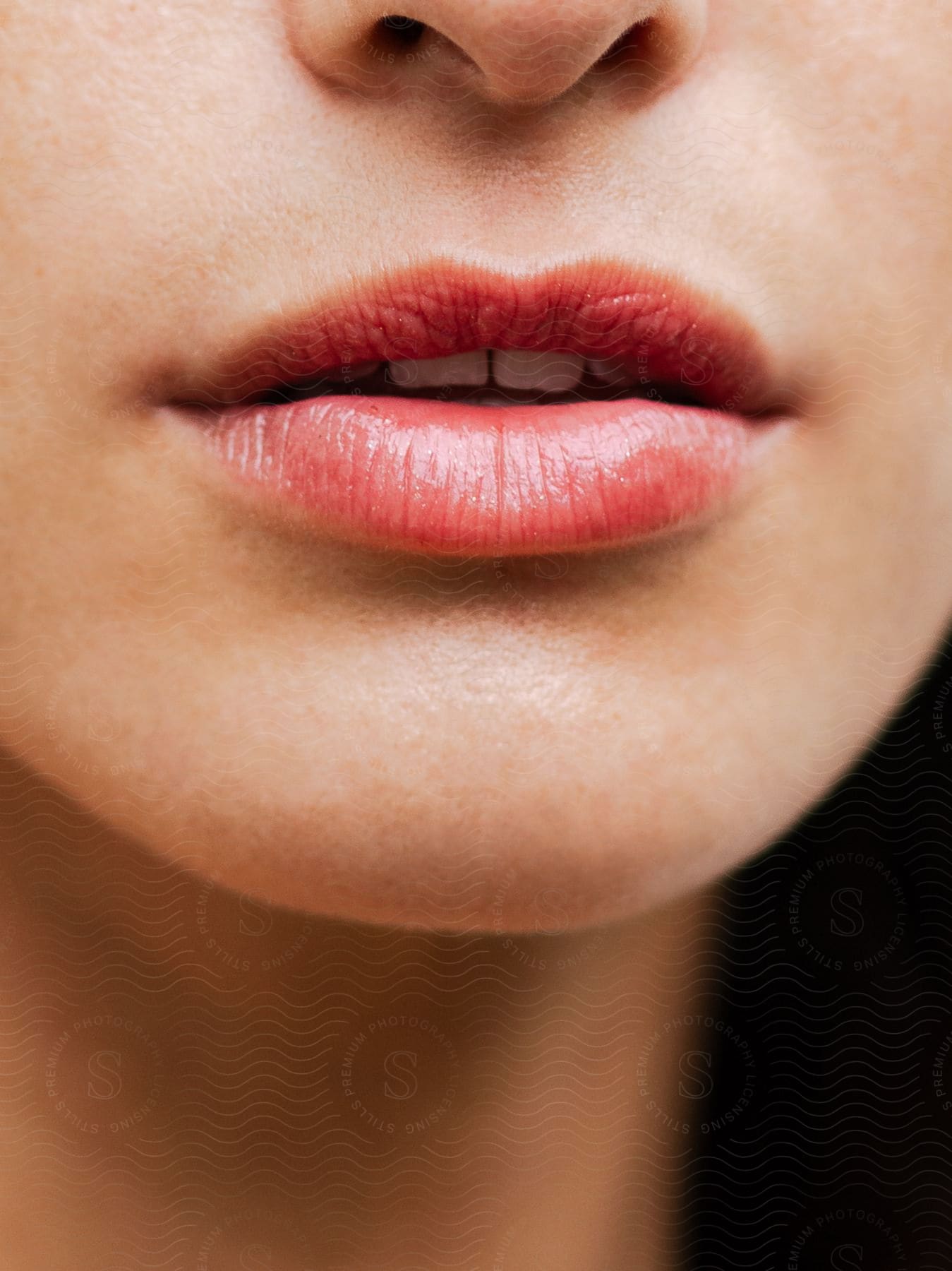 Close-up of a woman's mouth with light red lipstick