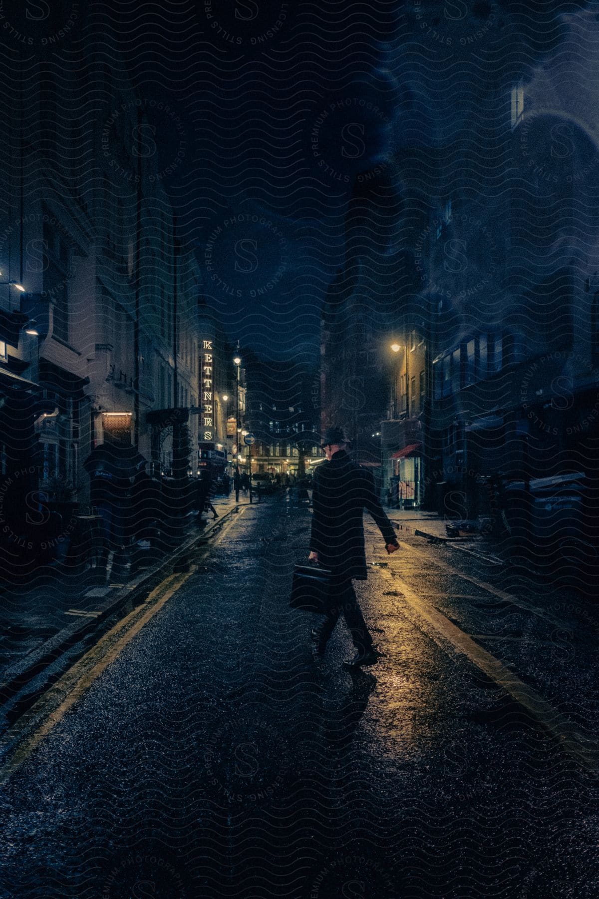 Man carries a briefcase across a rainy city street as people walk in the distance