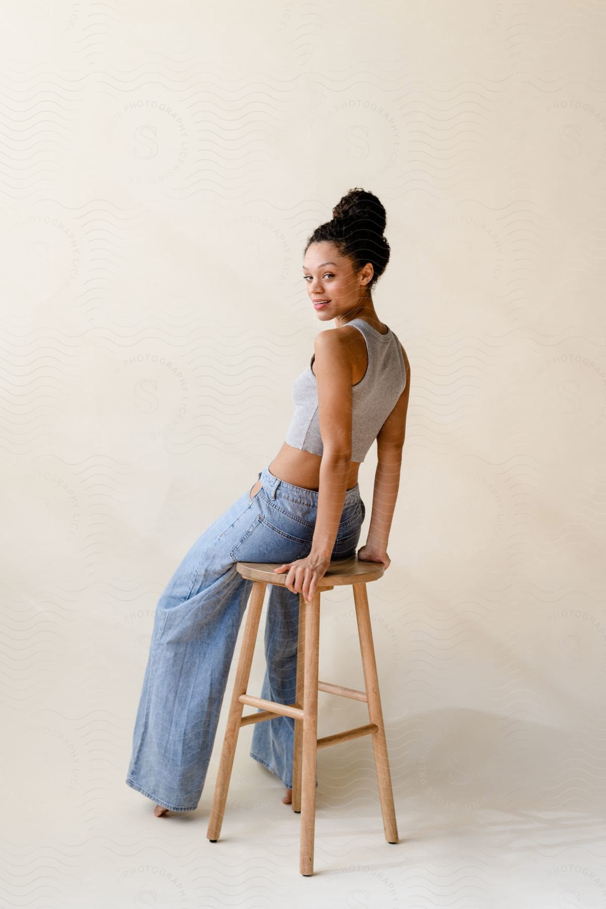 A woman sitting down on a bench modeling clothes.