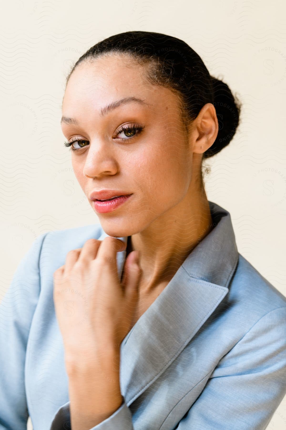 Woman looks into the camera with her hand under her chin