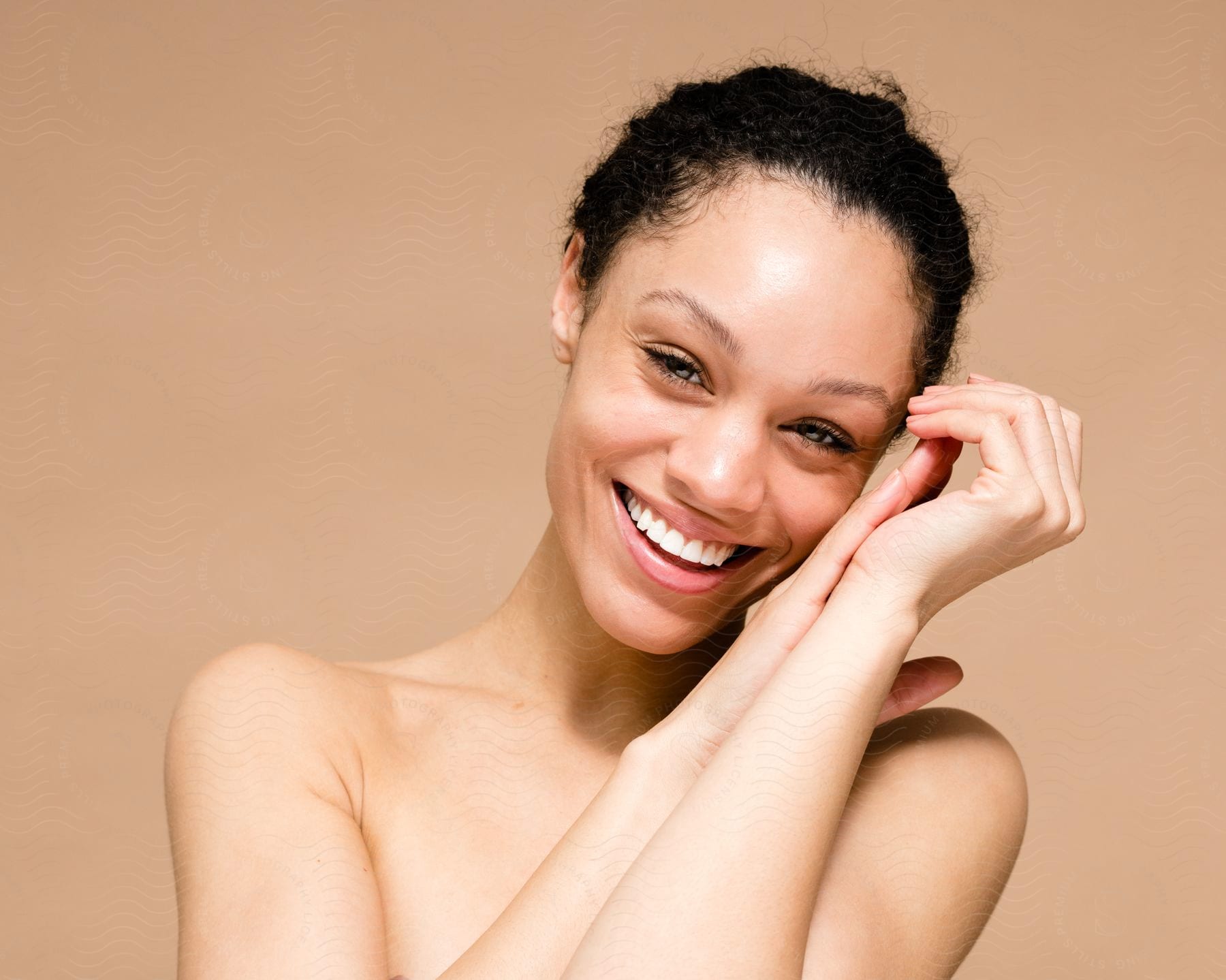 Woman holds her hands together as she laughs