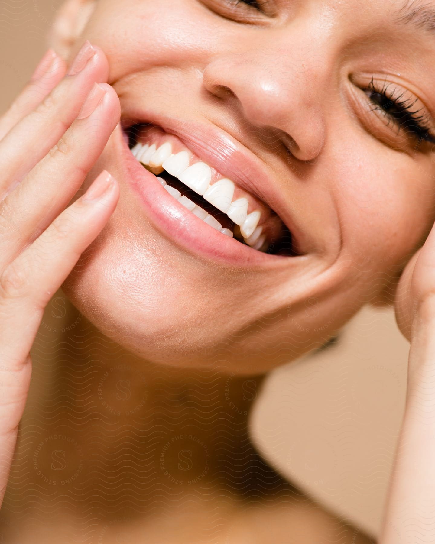 Woman touching her cheeks and laughing