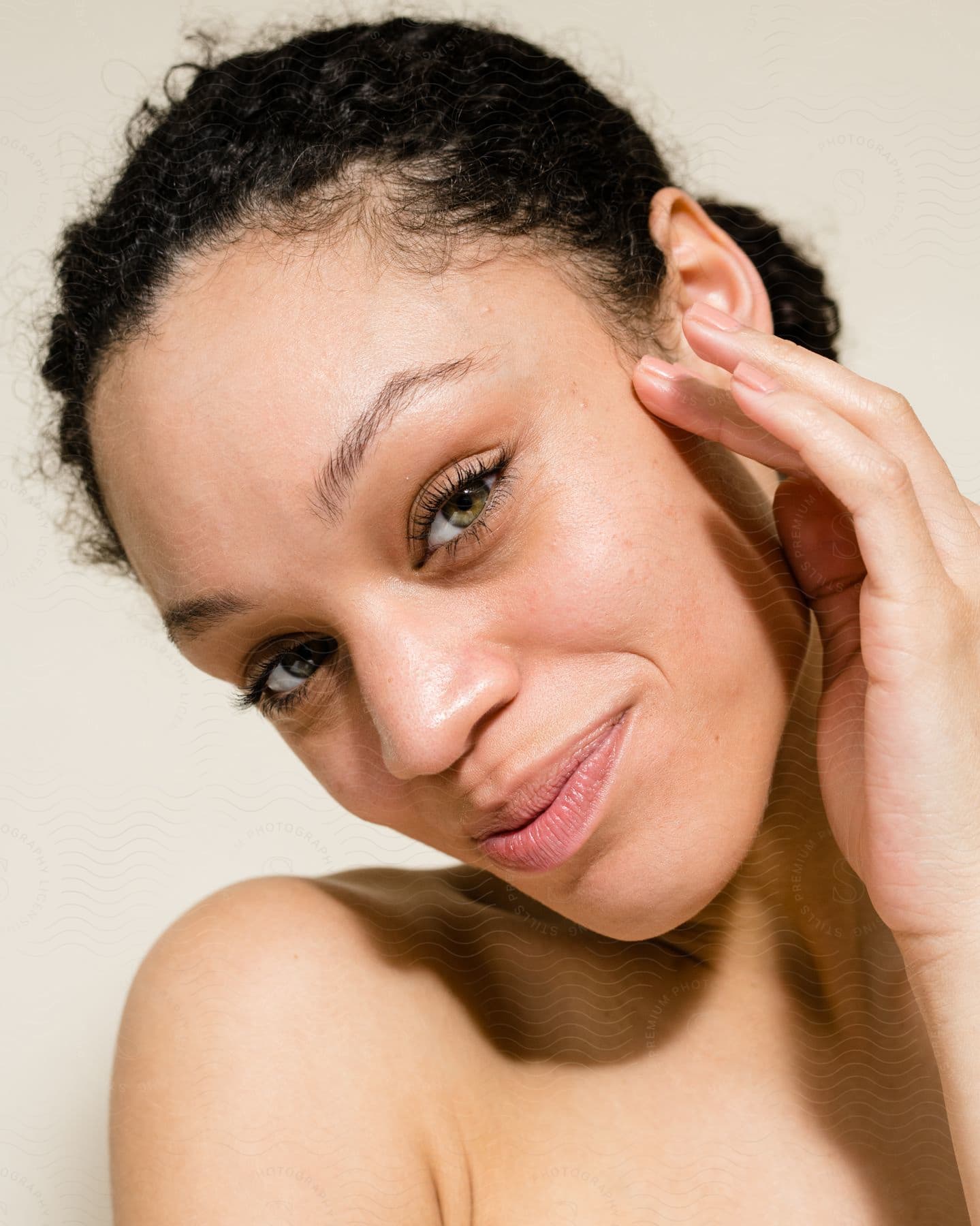 Face Of A Young Lady Smiling With The Left Hand On Her Cheek