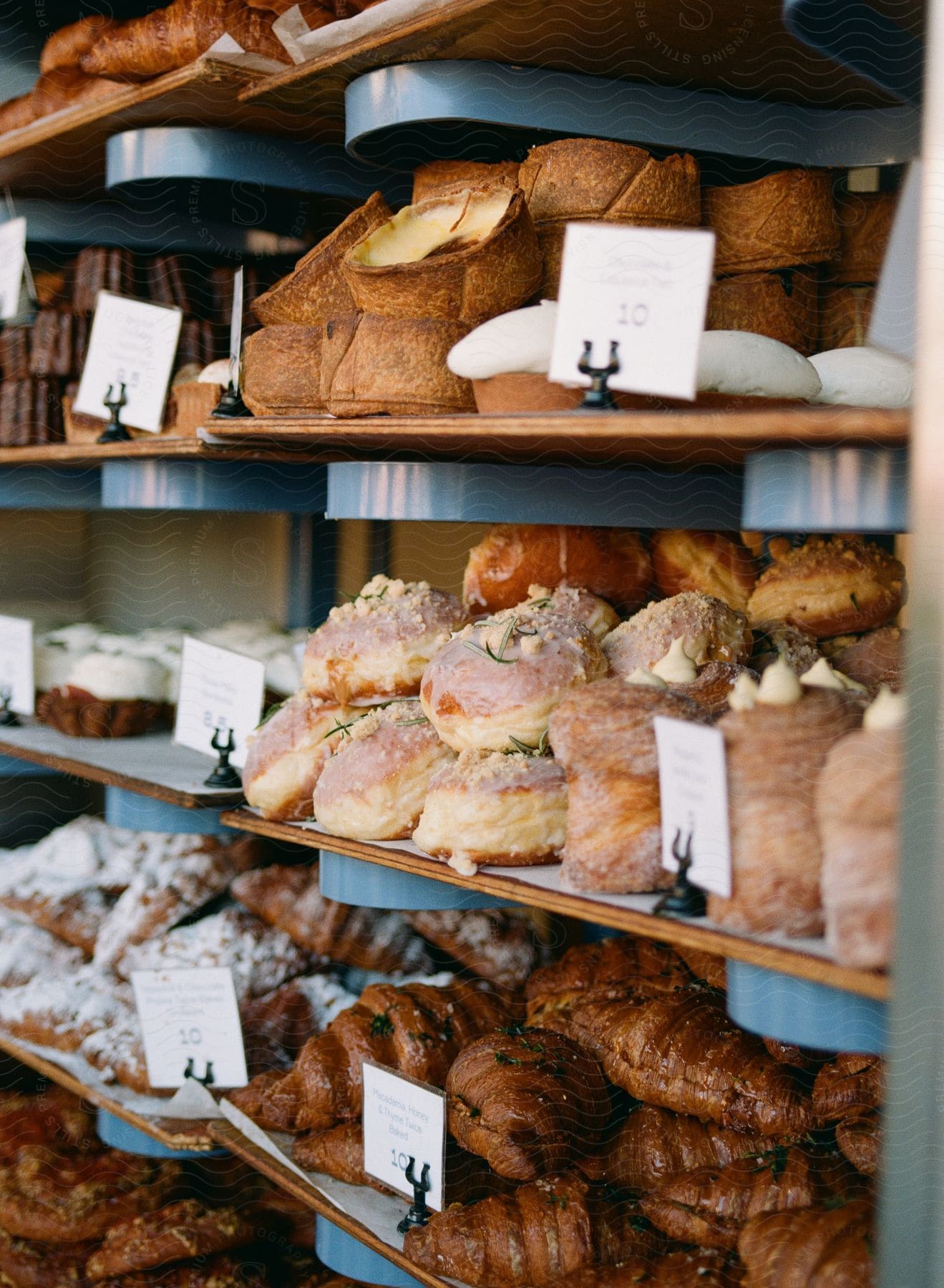 Sweet and savory baked goods on shelves with each food's nameplate