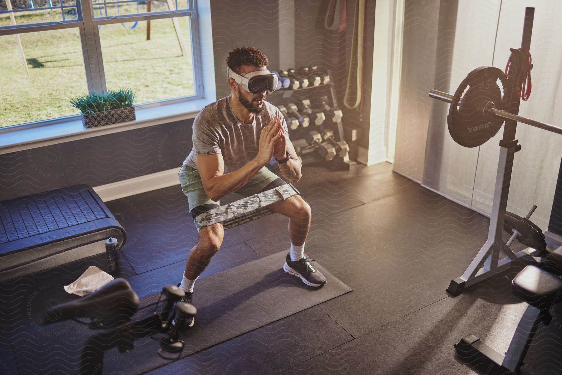 Man with virtual reality headset and a beard does cardio workout in the gym