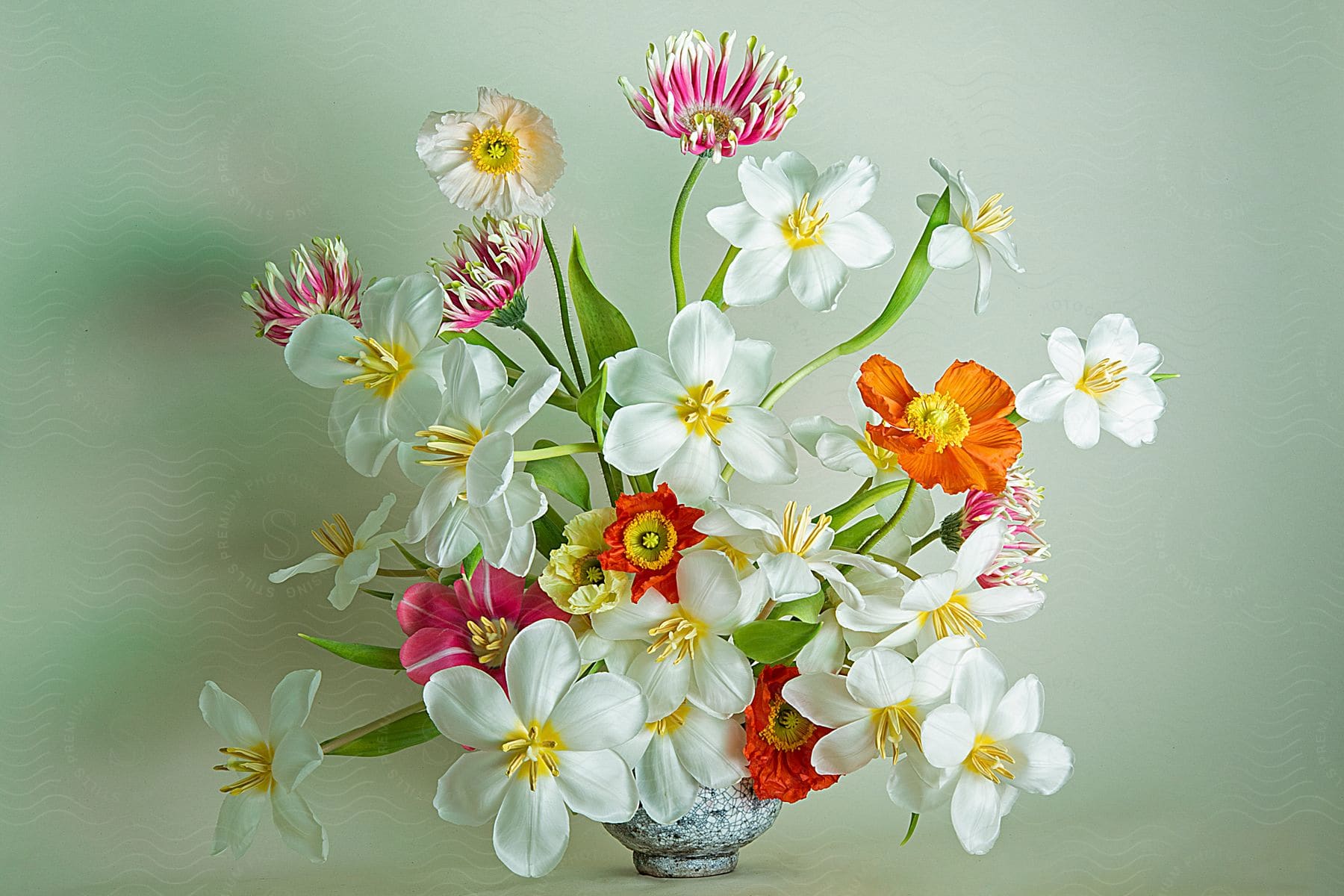 Bouquet of flowers in a ceramic jug on gray background