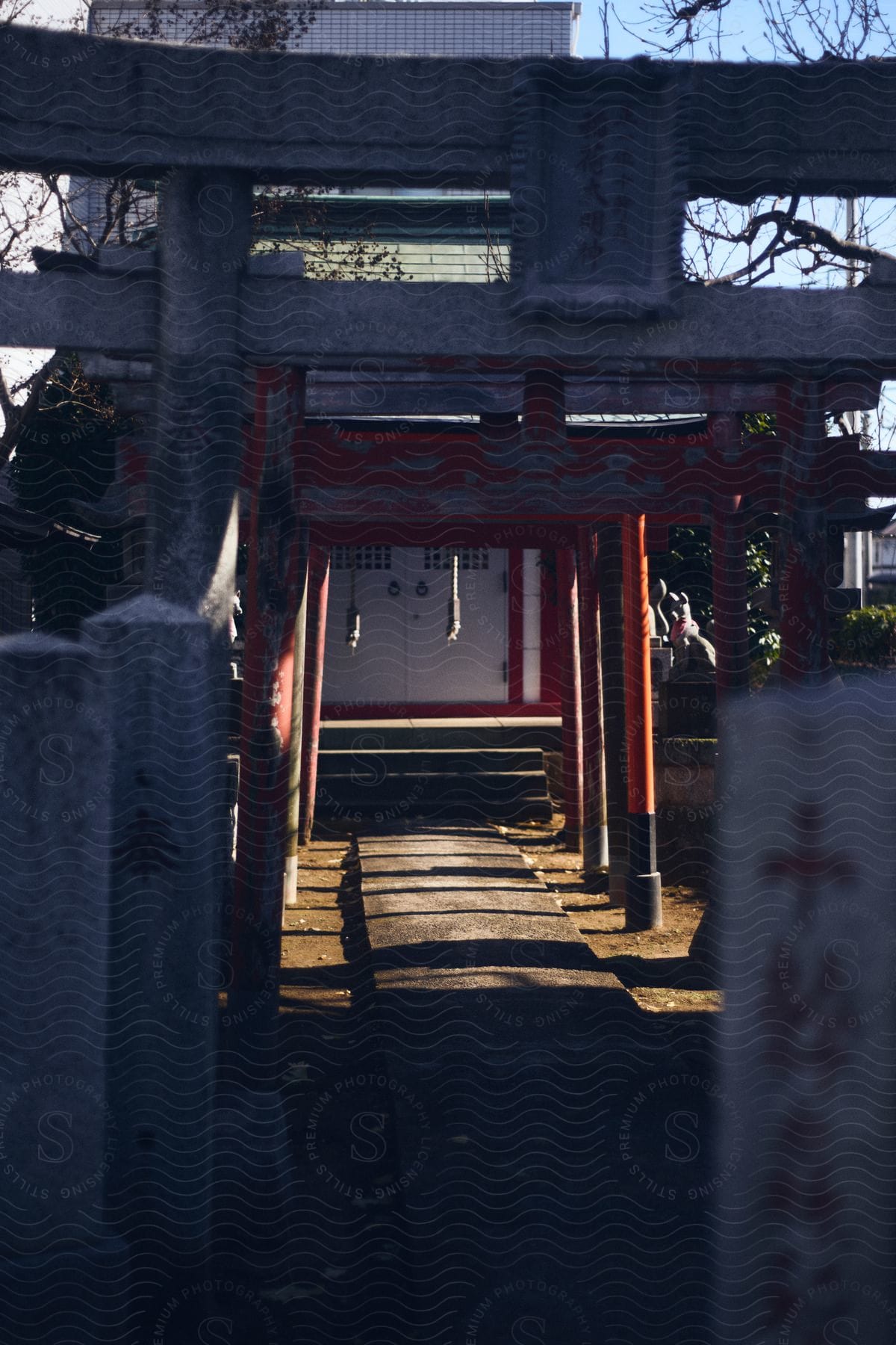 a pathway leading into a building with white doors